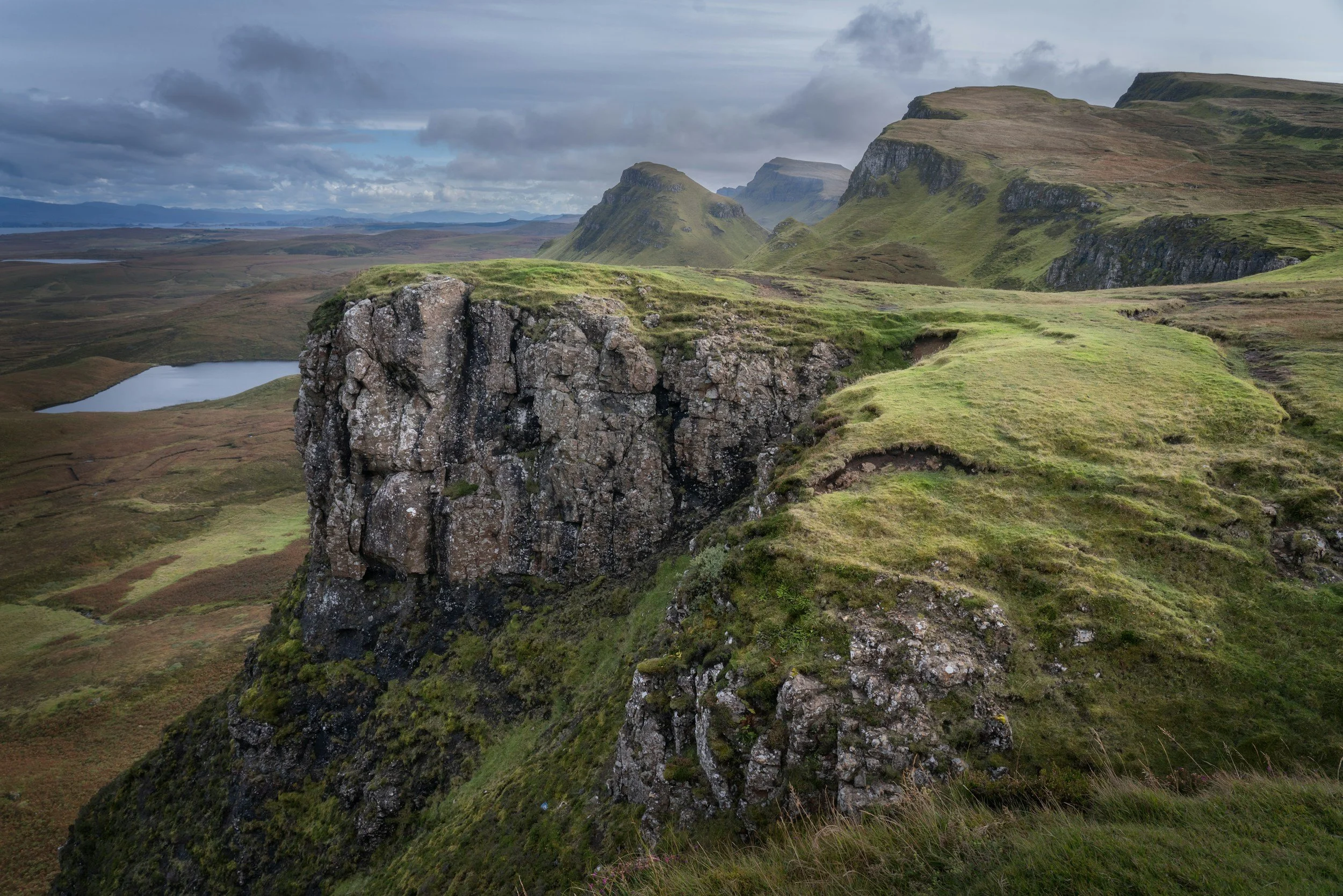 Rocky screen landscape overlooking the Isle of Skye Scotland. Moody sky with clouds