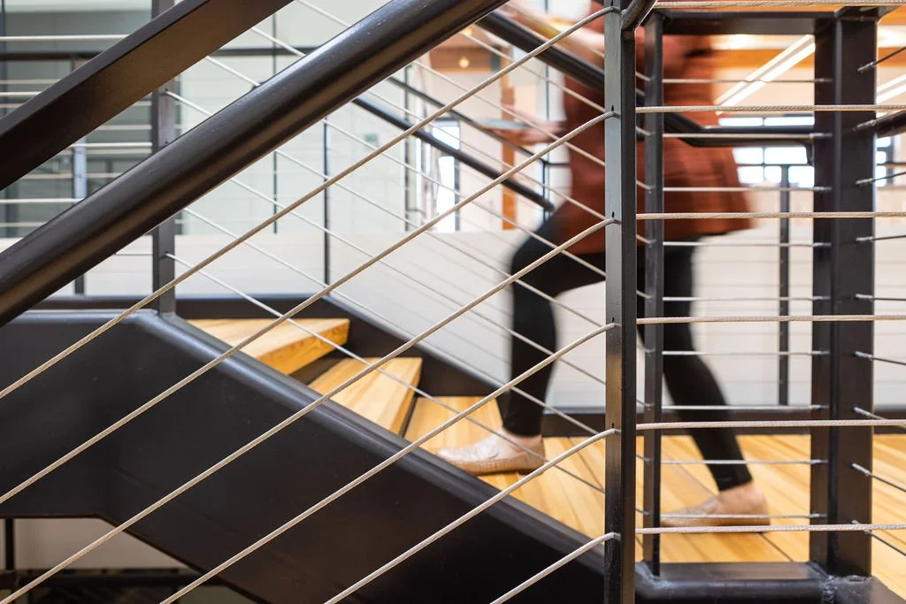 Modern office staircase representing structured growth and scalable systems for business owners