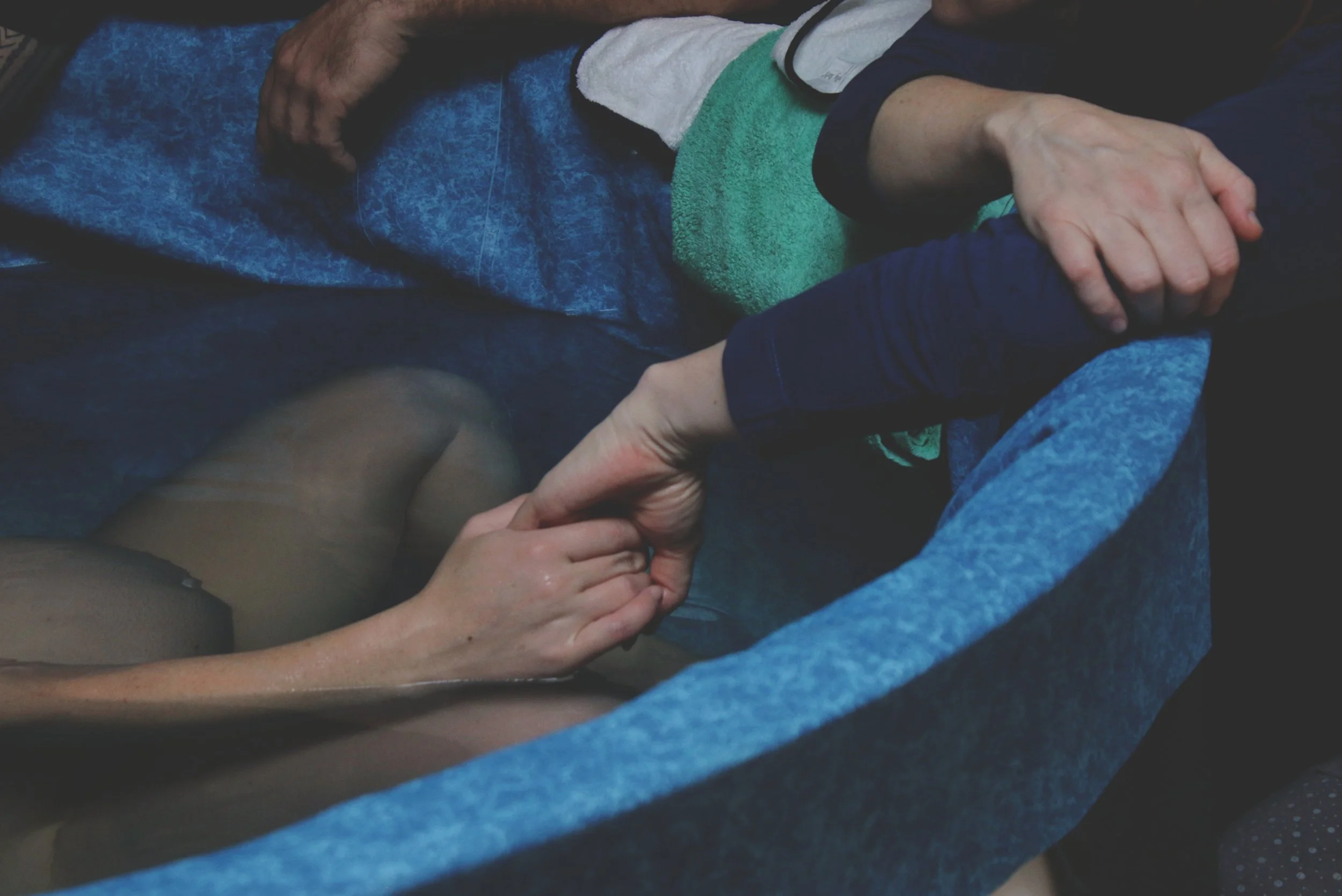 doula holding a mother's hand