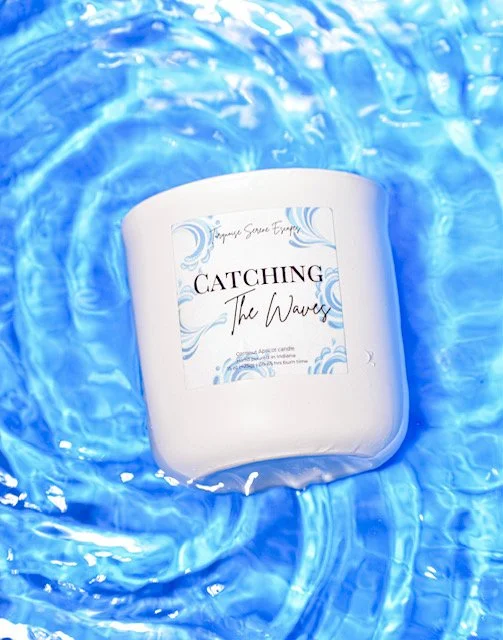 white ceramic jar candle in a shallow blue pool of water