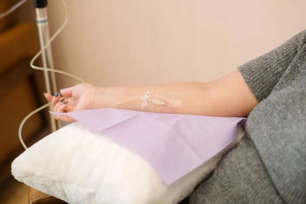 Patient relaxing during supervised IV iron infusion treatment