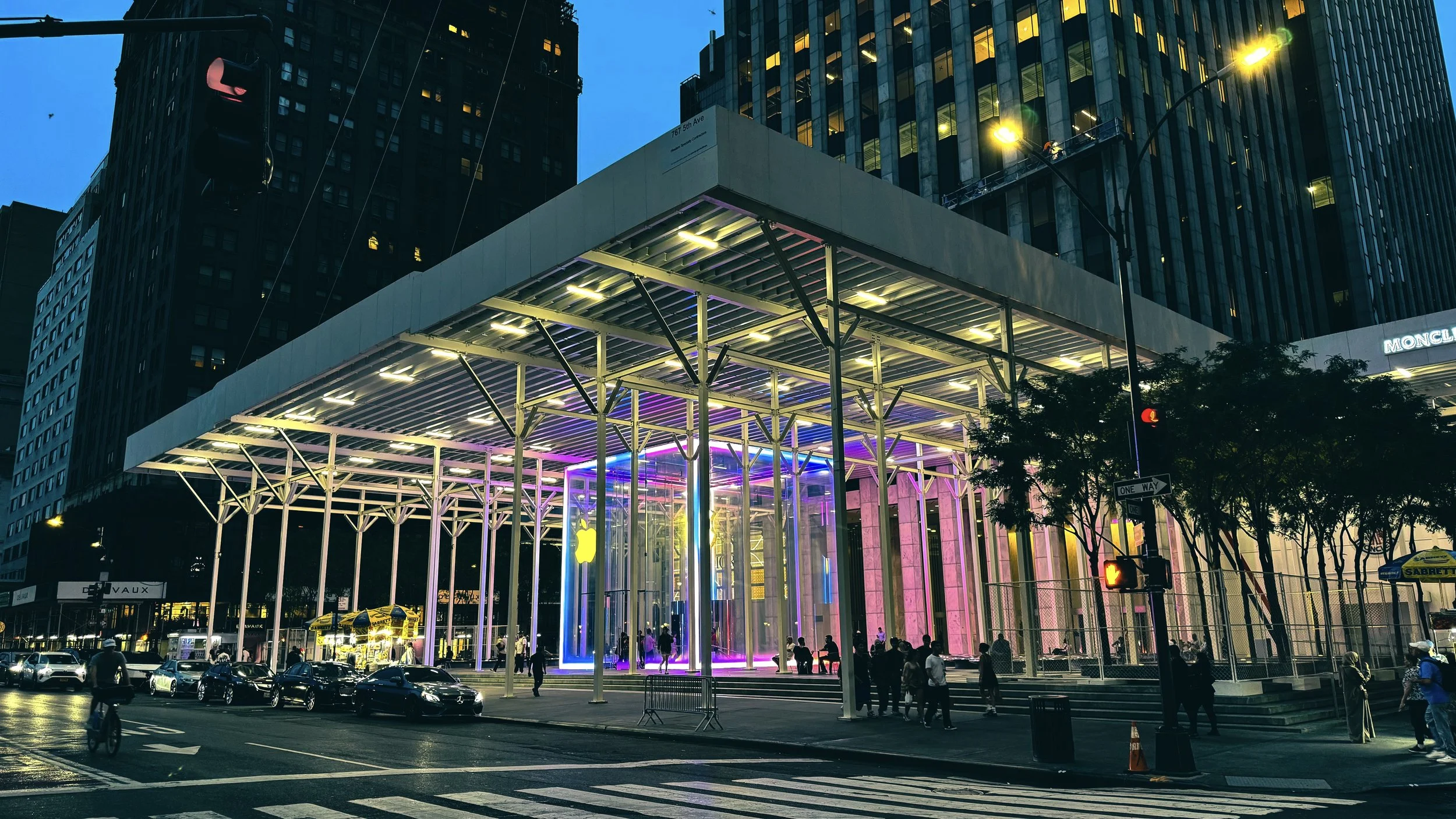 Apple Store exterior in Manhattan NYC at night featuring glass cube entrance and illuminated modern architectural structure