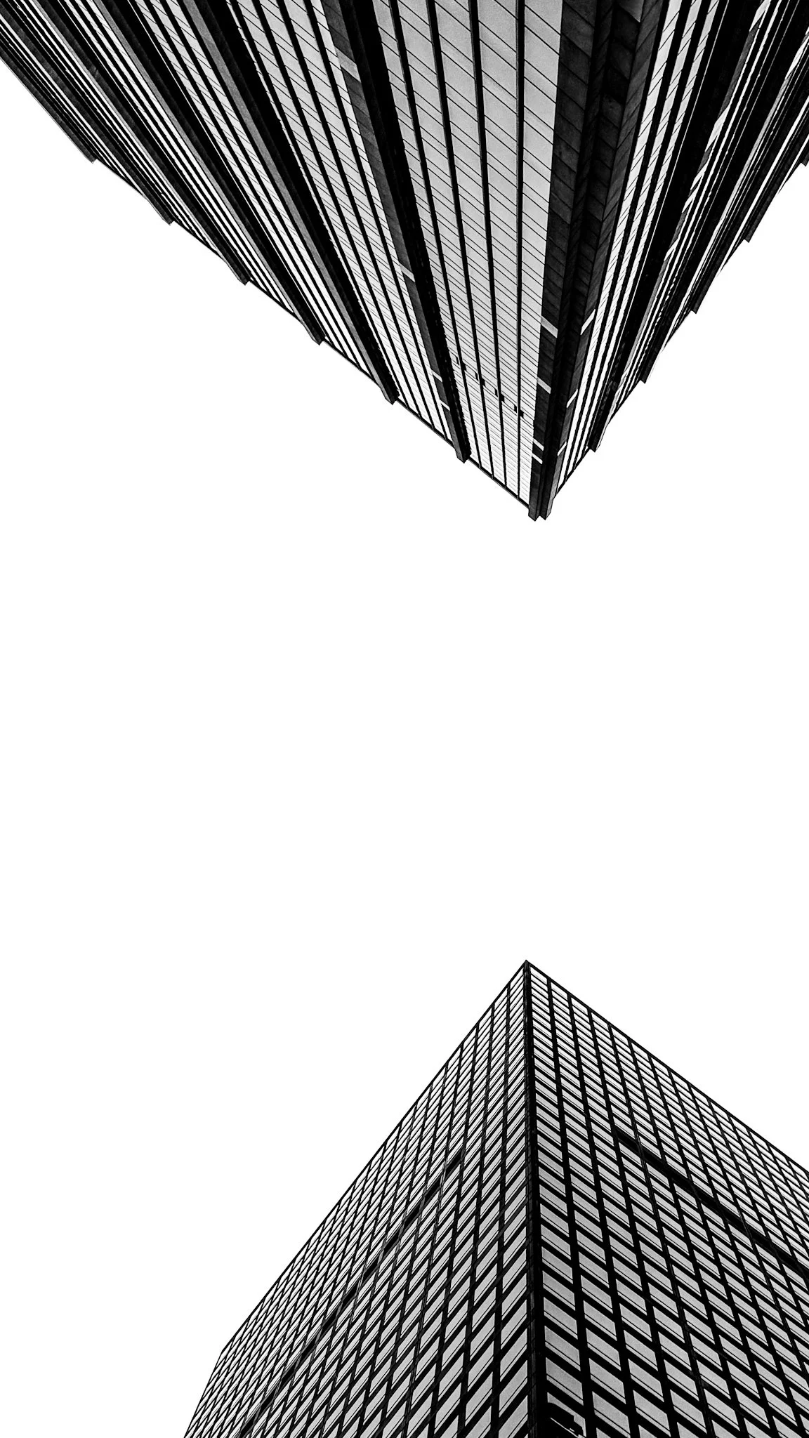 Minimalist low angle view of modern glass skyscraper corner in Manhattan NYC with strong geometric composition