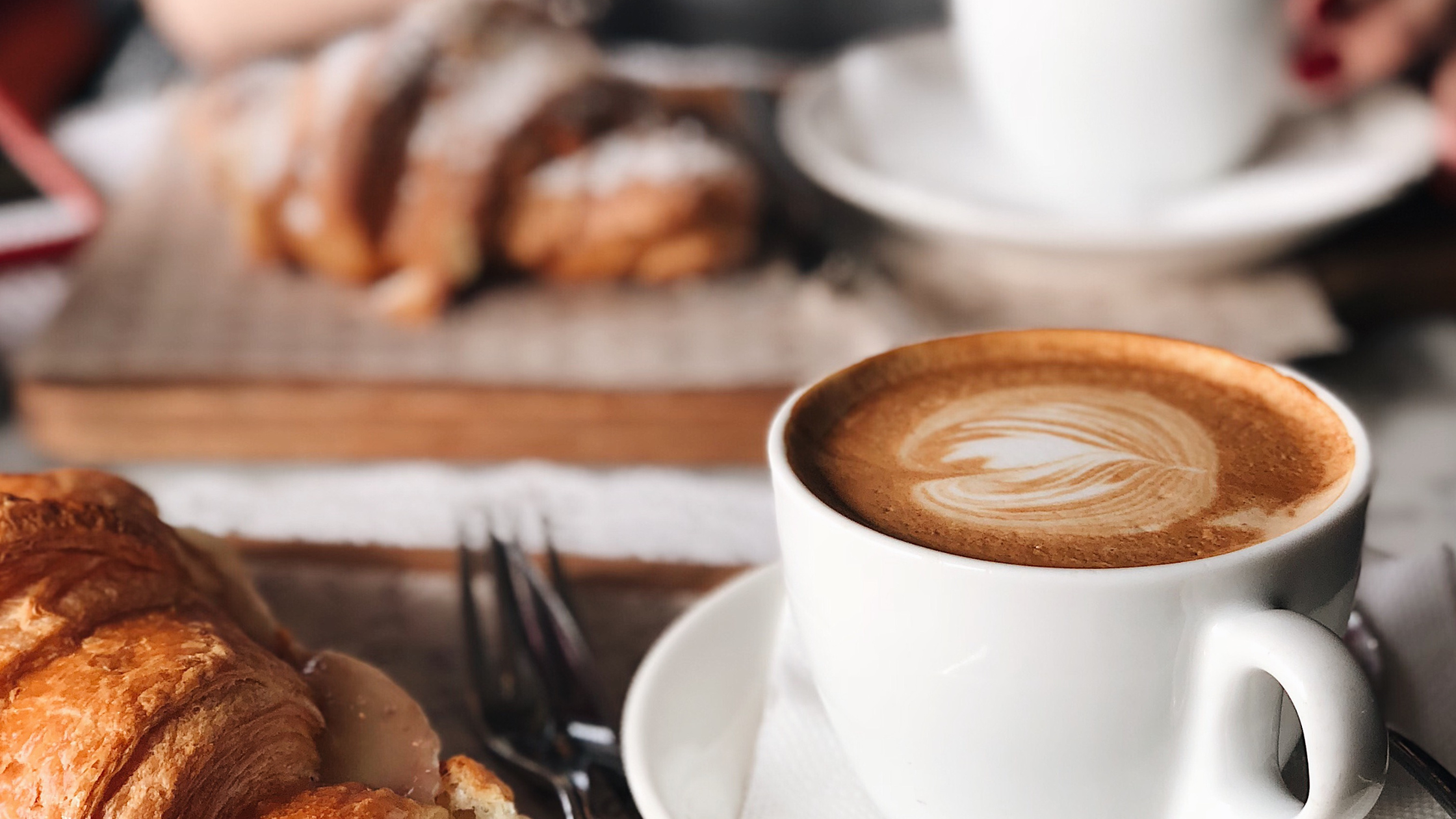 Photographer meeting a client for coffee to discuss business, representing deductible meal expenses for photography businesses.