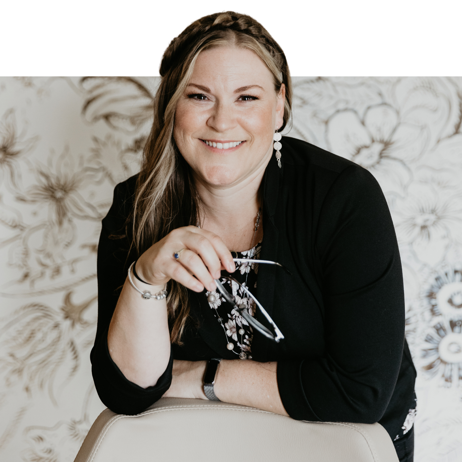 Tiffany Bastian, Enrolled Agent and founder of Bastian Accounting, smiling and holding her glasses