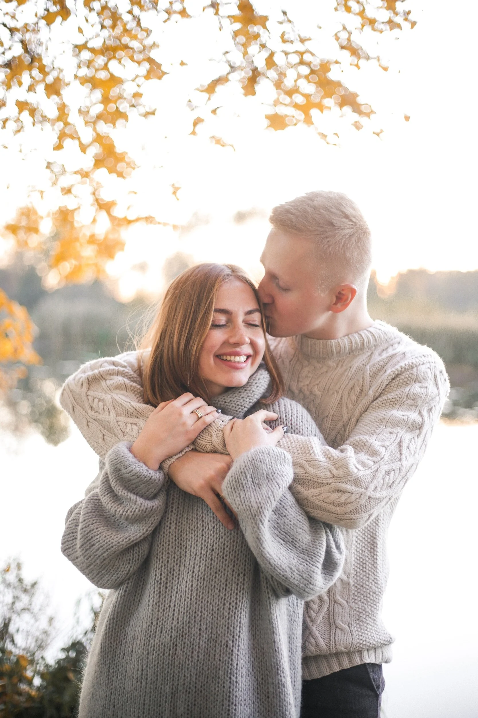 In this image we can see a couple very much in love hugging