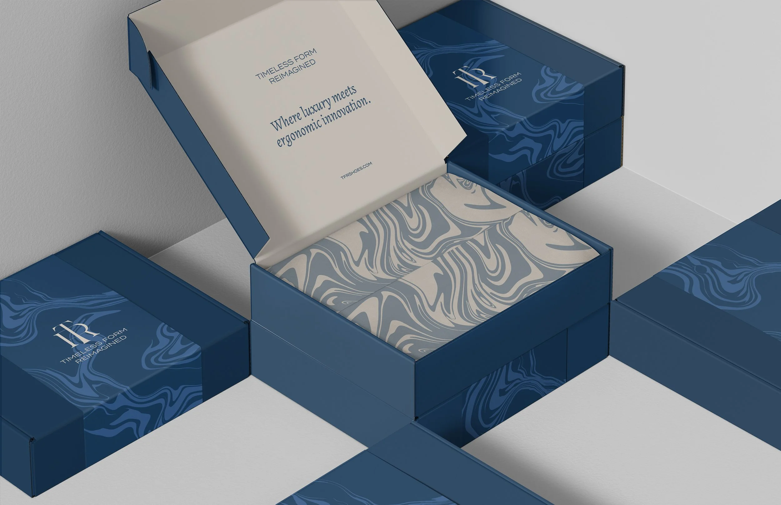 Open blue boxes with white and blue marbled tissue paper inside, branded with 'TIMLESS FORM REIMAGINED' and abstract blue patterns.