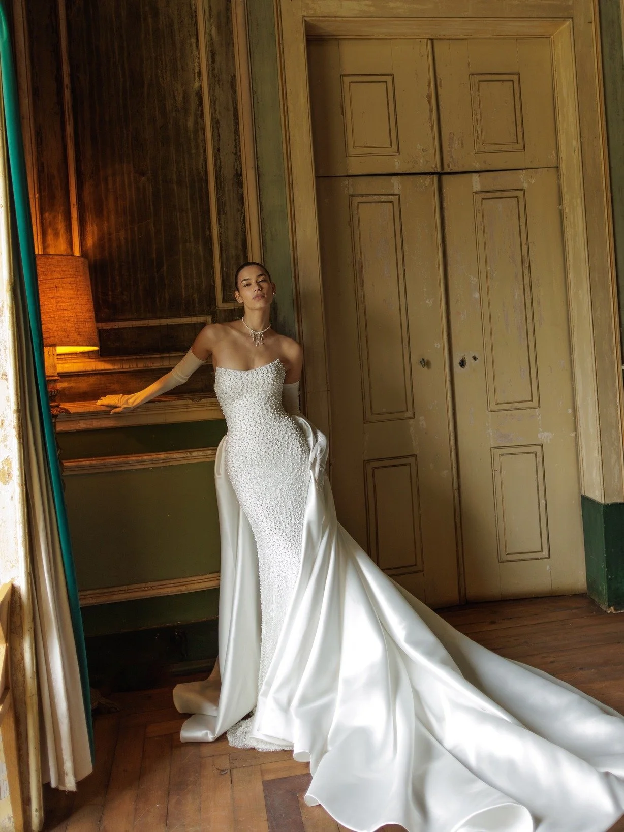 Artemis, arriving for our WONA Bridal Alchemy Trunk Show from December 4&ndash;18. A fully pearl-embroidered, fitted gown with a soft boat neckline, detachable sleek gloves, and a dramatic satin infinity-bow that transforms into a sweeping train. Sop