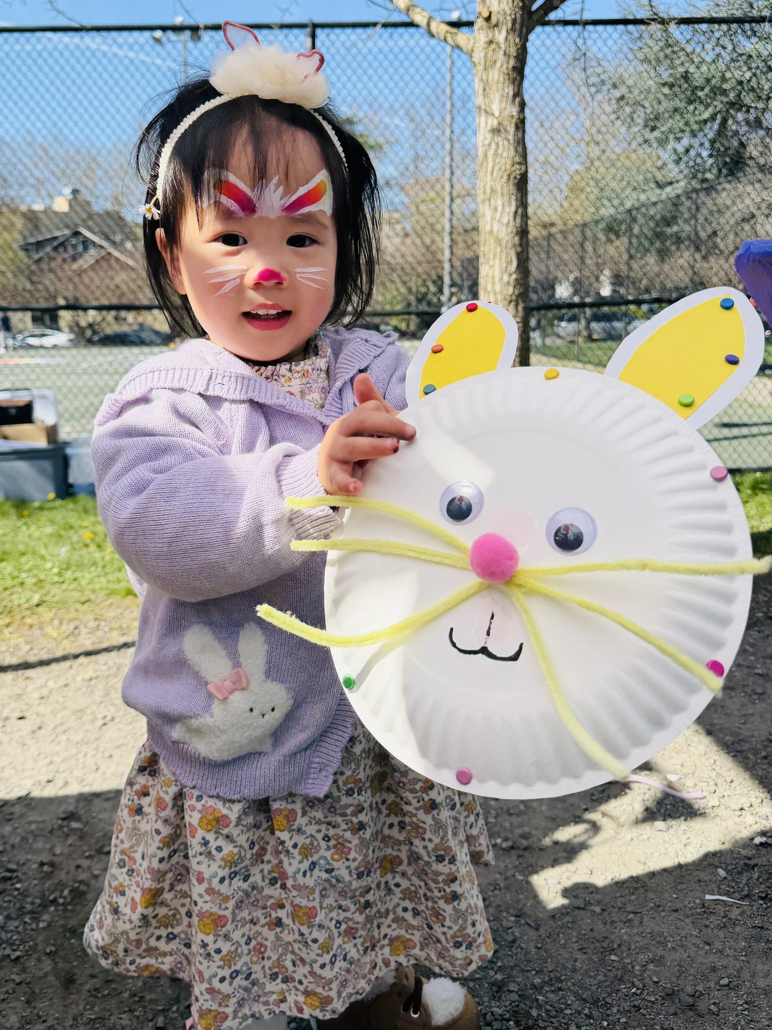 little girl with bunny craft and face paint