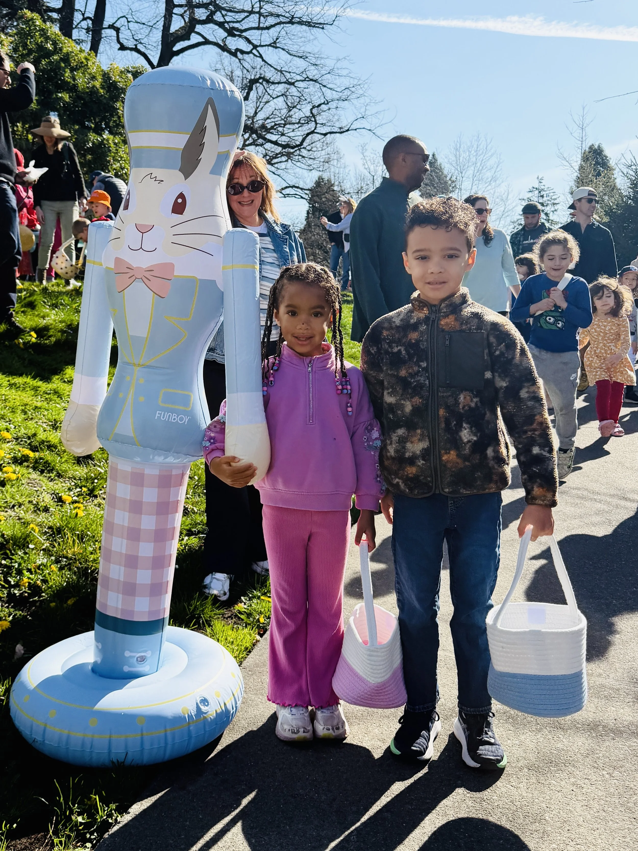 two kids at easter egg hunt with Funboy bunny nutcracker inflatable