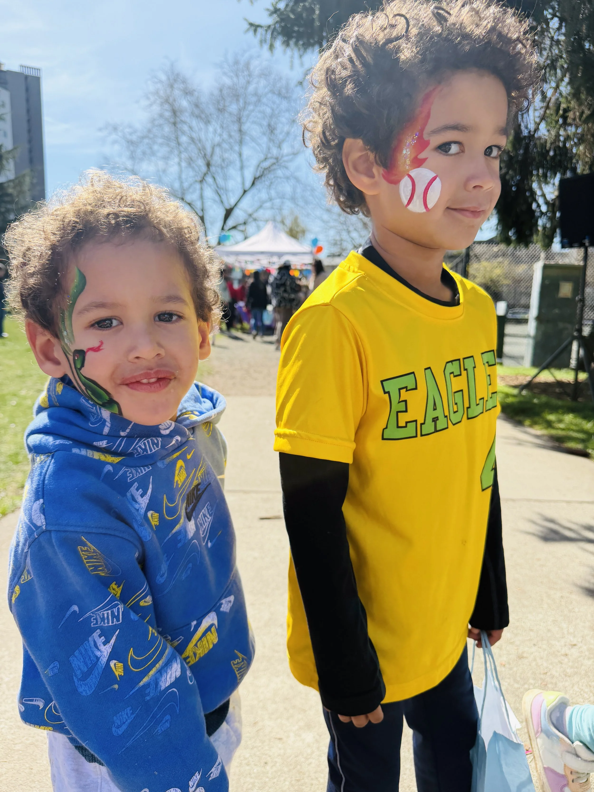 two kids with face painting by Hoolpa at Madison park easter egg hunt