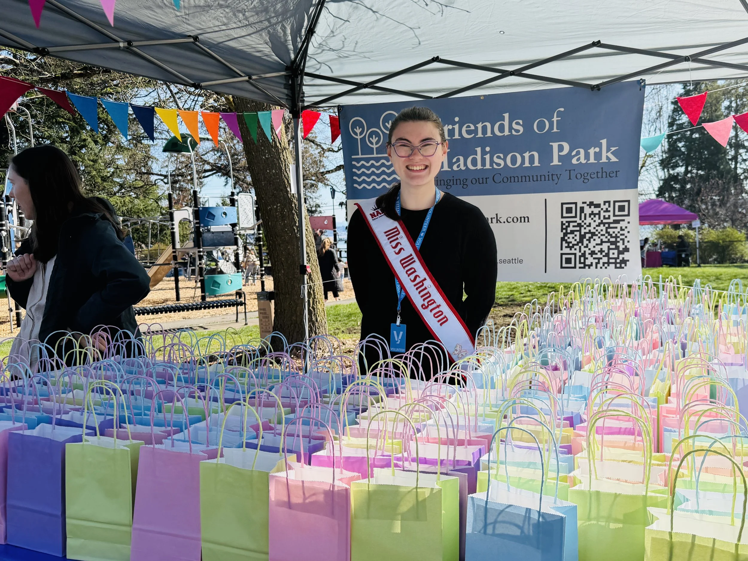 Miss Washington with pastel bags at Friends of Madison Park booth