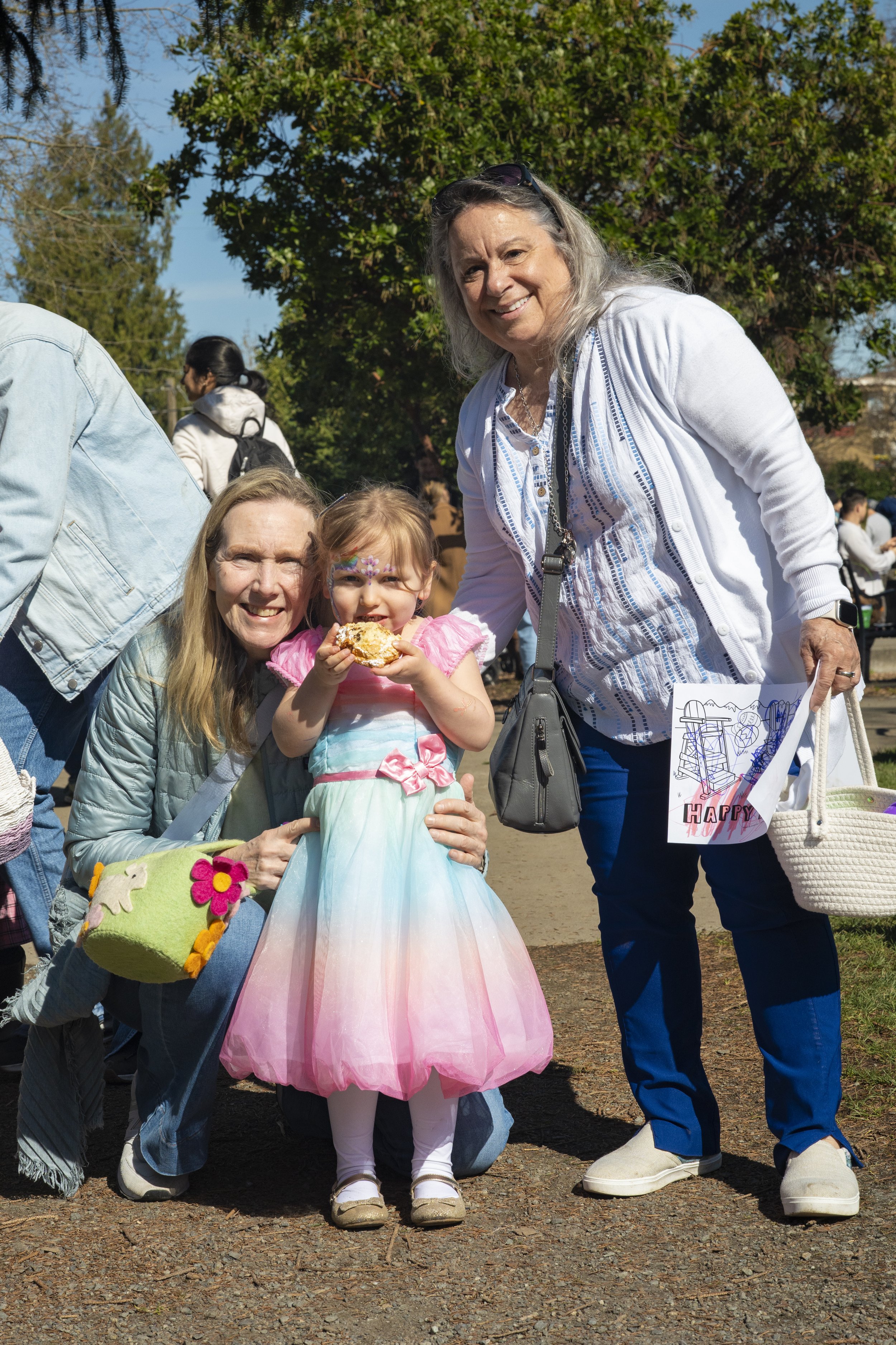 mom and grandma and little girl in easter dress at madison park easter egg hunt
