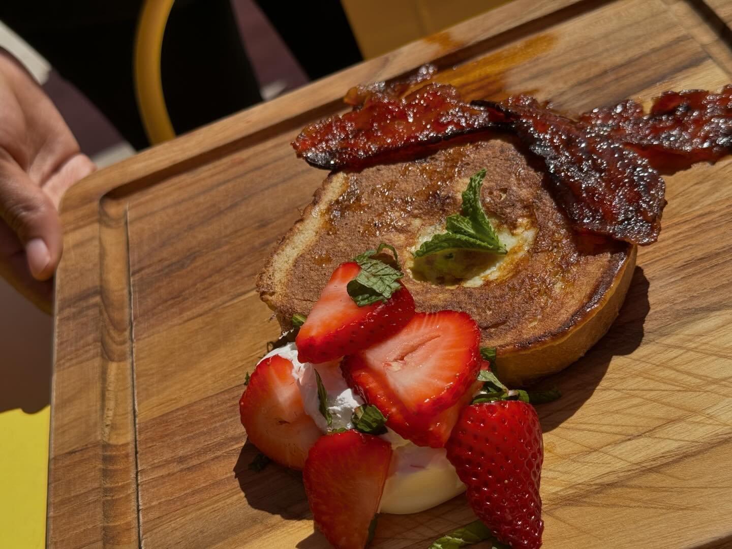 Brunch specials today! First up, from @homegrownmountholly: Ladybug Bakery cinnamon bread French toast with quail egg from Ed&rsquo;s Eggs, hot honey-glazed bacon, and fresh strawberries. Next up: grilled pork chop over cheese grits with easy egg. Ju