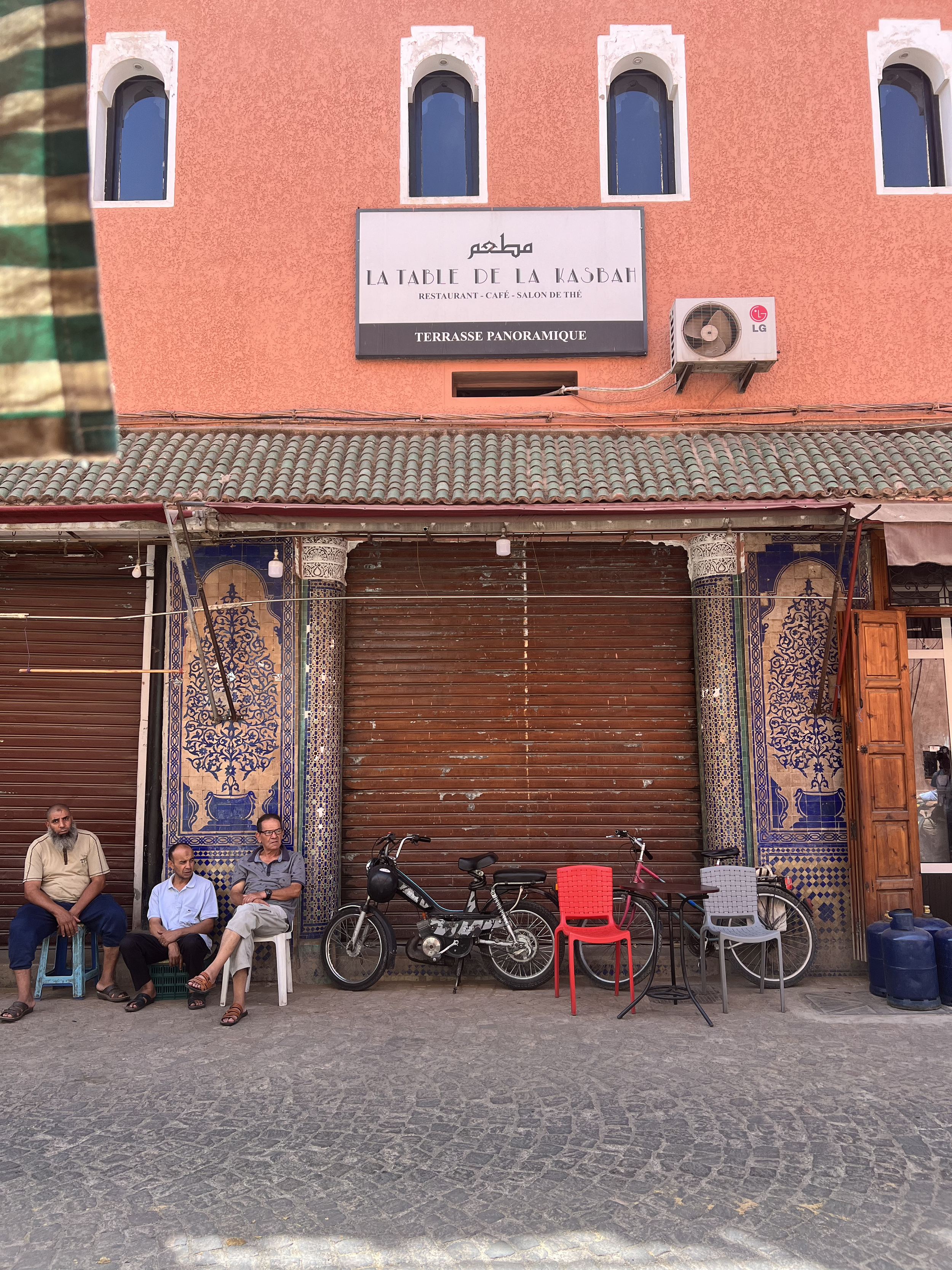 Medina men sitting by wall.png