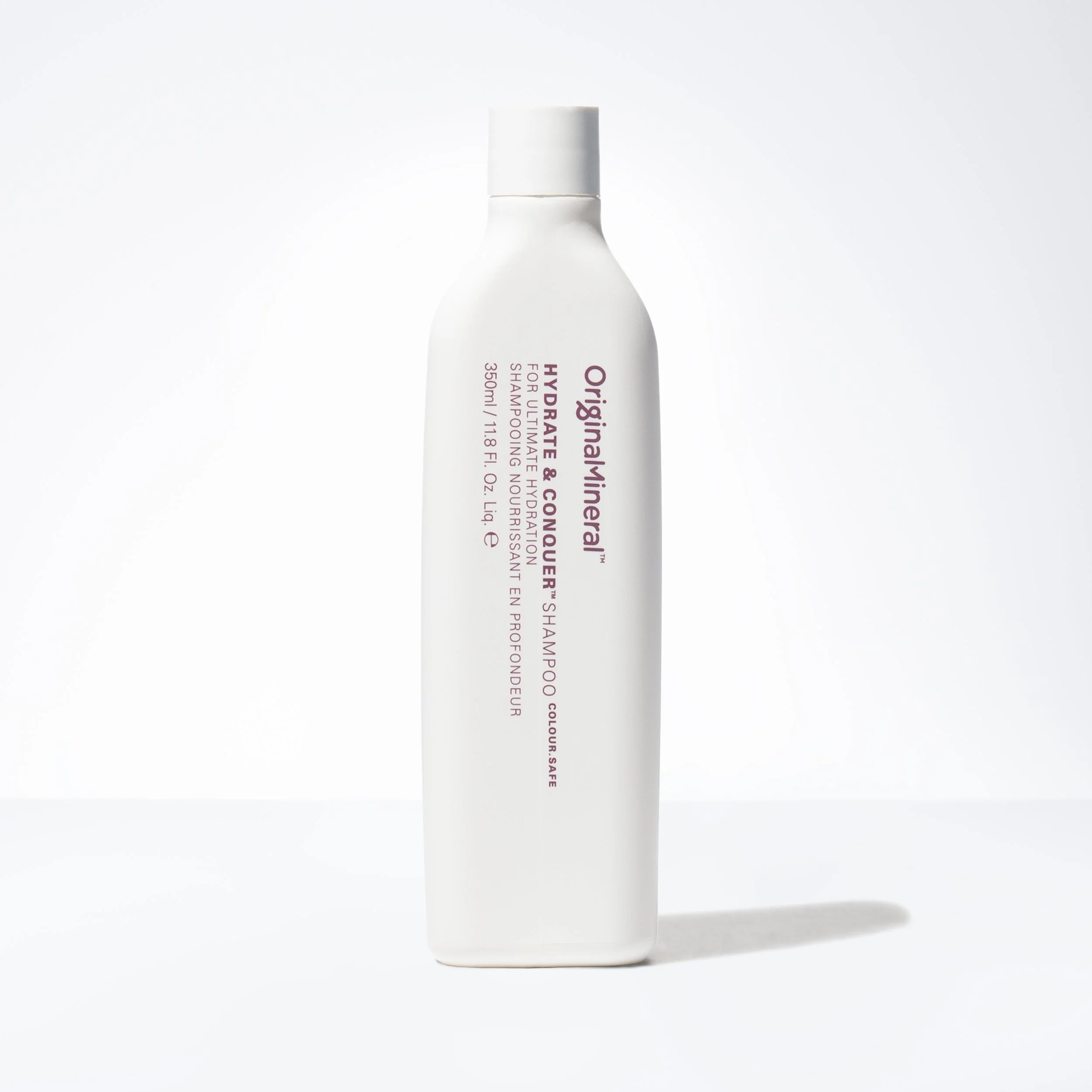 Bottle of Original & Mineral Hydrate & Conquer Shampoo on a white background.