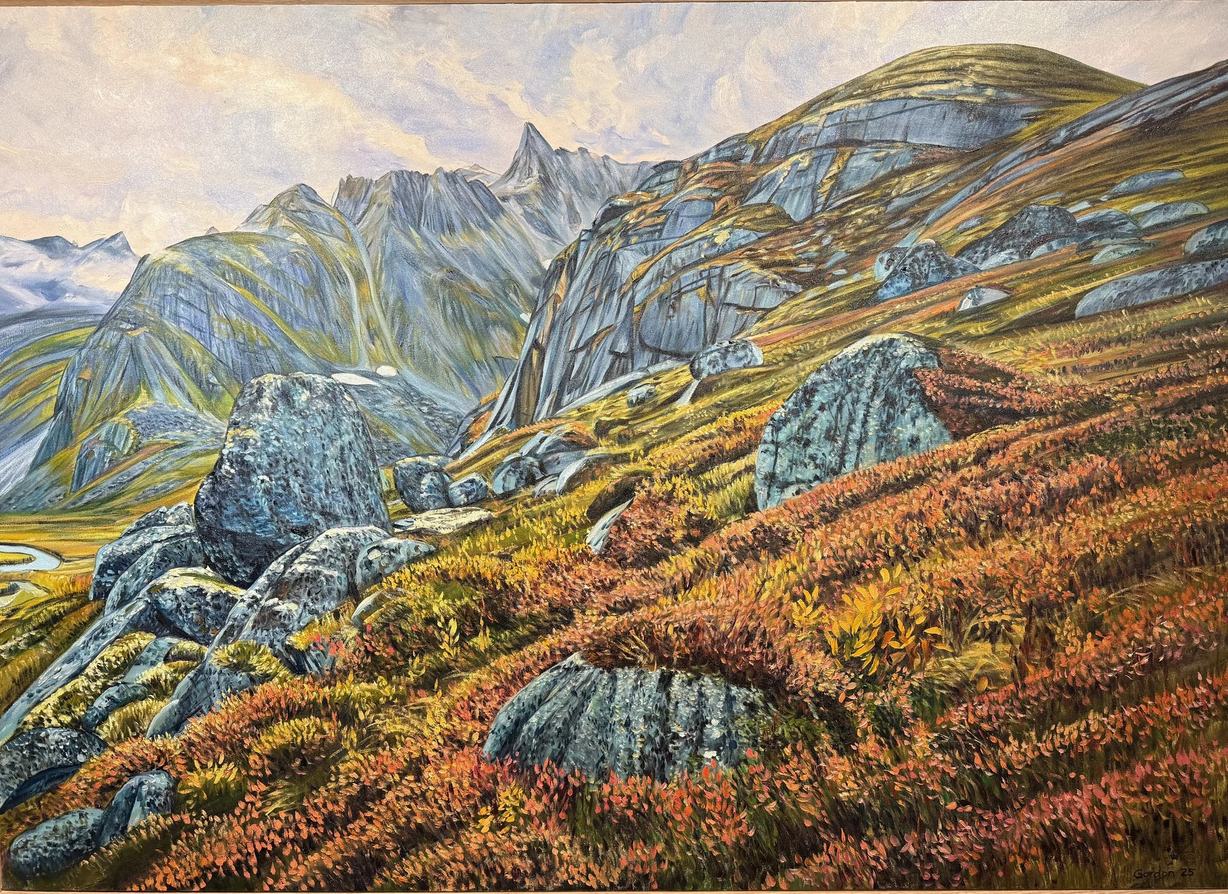 A landscape painting of mountainous terrain with colorful rocks, mountains, and valleys, featuring vibrant red, orange, yellow, and green foliage.