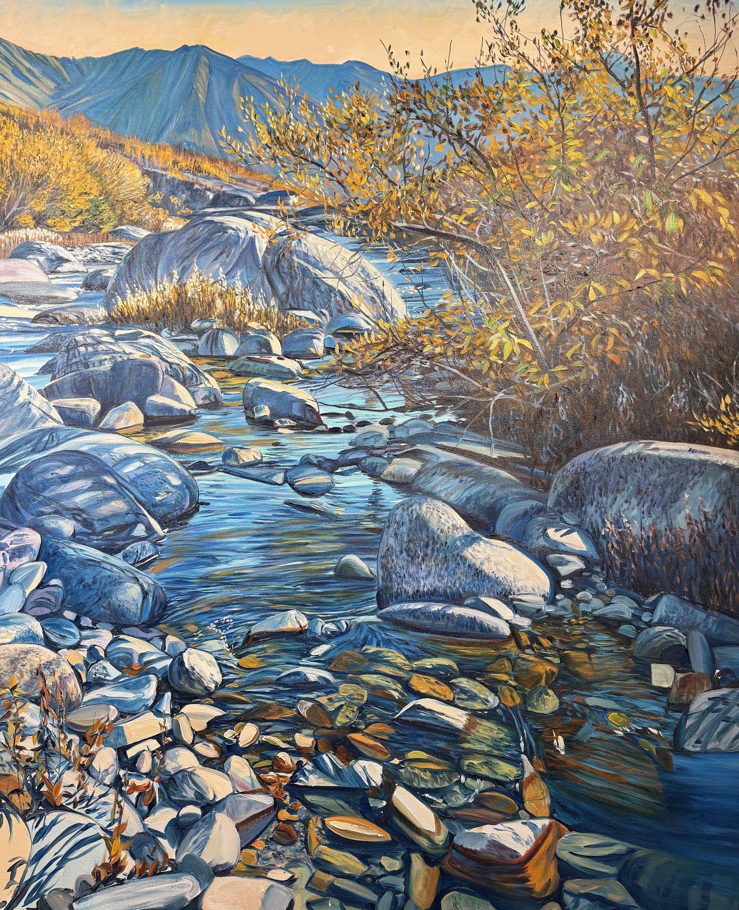 Landscape painting of a rocky river with mountains in the background, autumn foliage on the trees, and a clear sky during sunset.