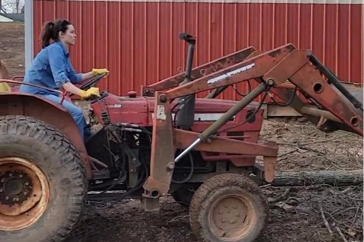 Kelly driving a rusty old tractor with no brakes.