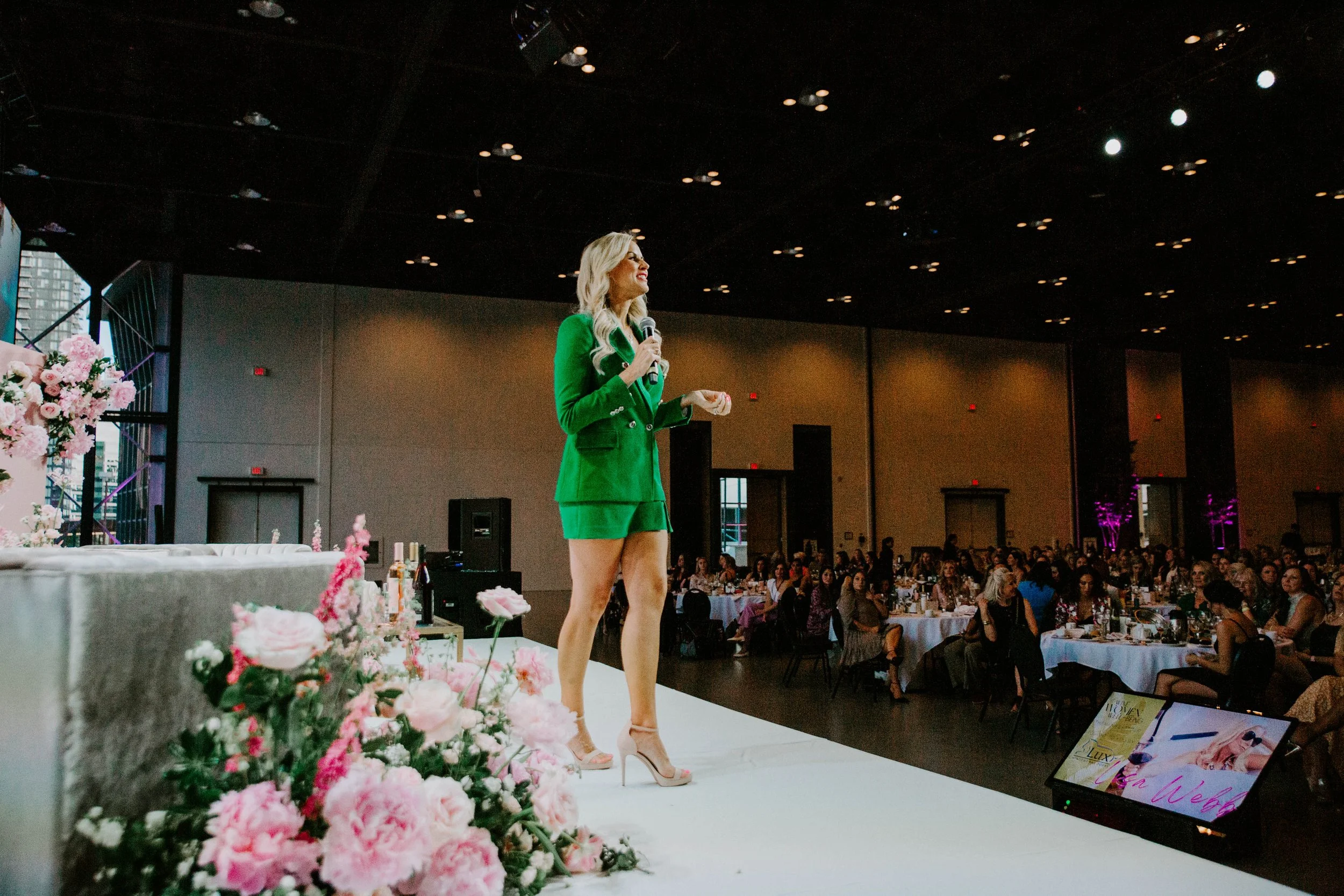 Lisa Webb in a green suit speaking in Calgary