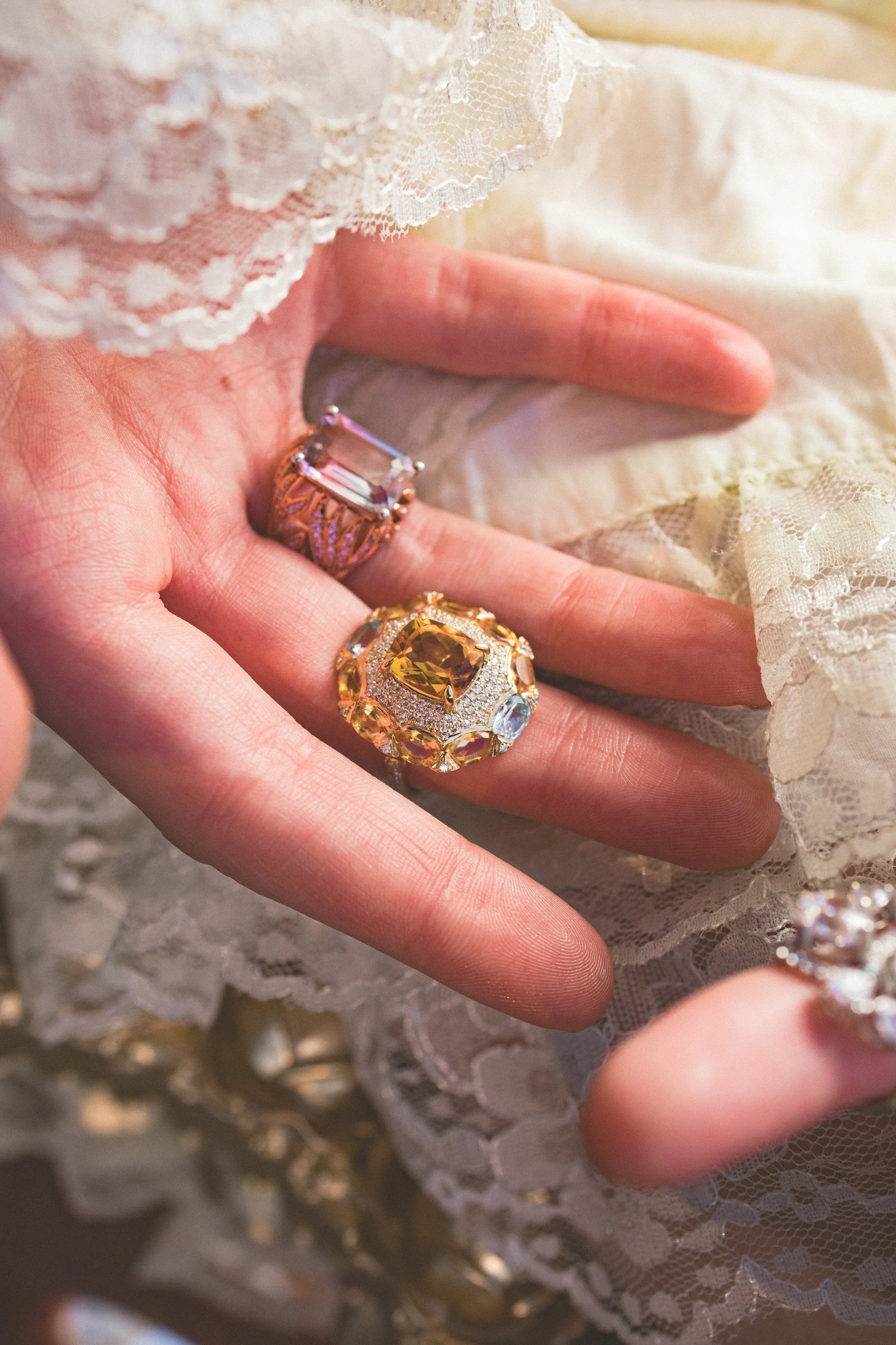 Model's hands featuring Nightfall in Nairobi and Arise from the In Your Dreams collection by Gerard Rene, a private NYC atelier.
