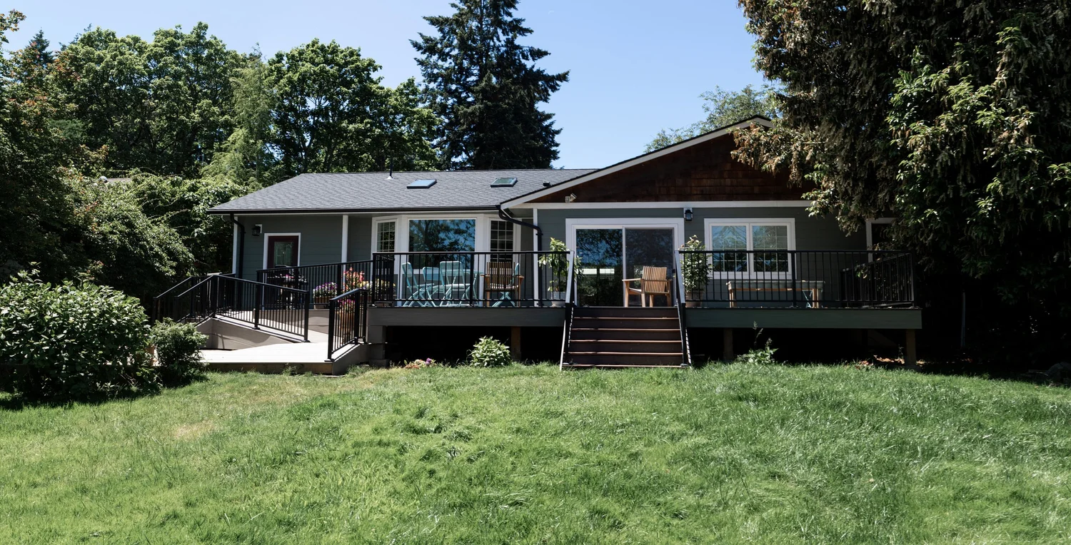 The back of a home with a newly built deck and railing