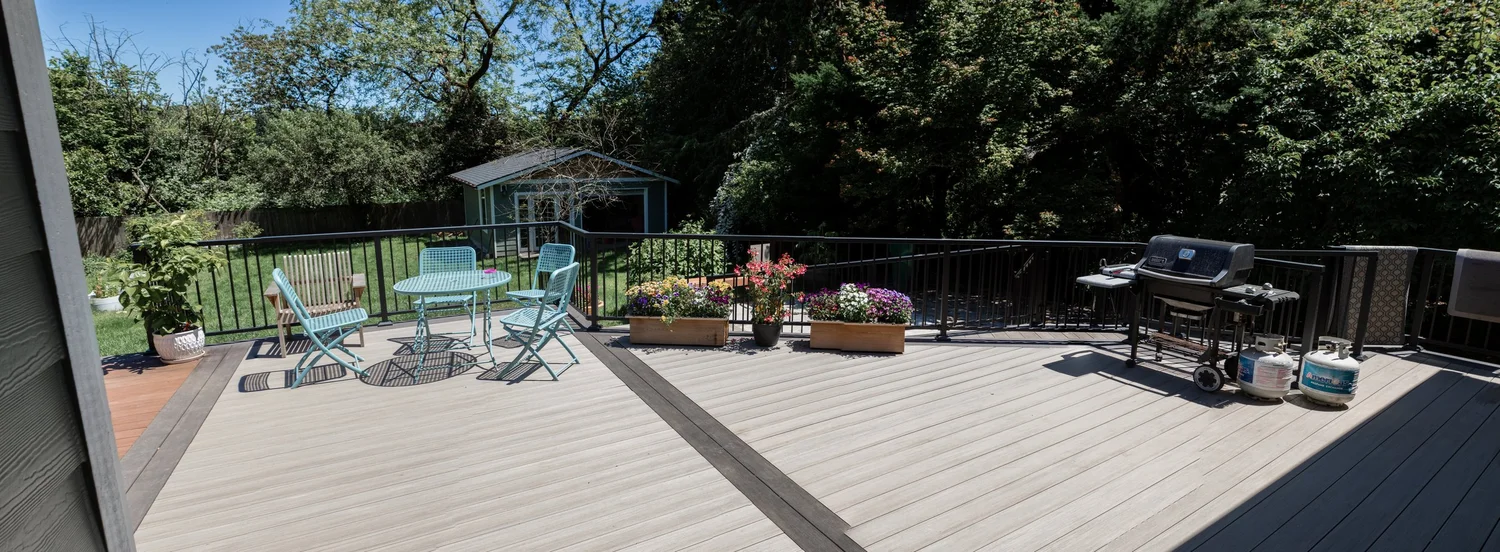 A large deck with outdoor seating among trees
