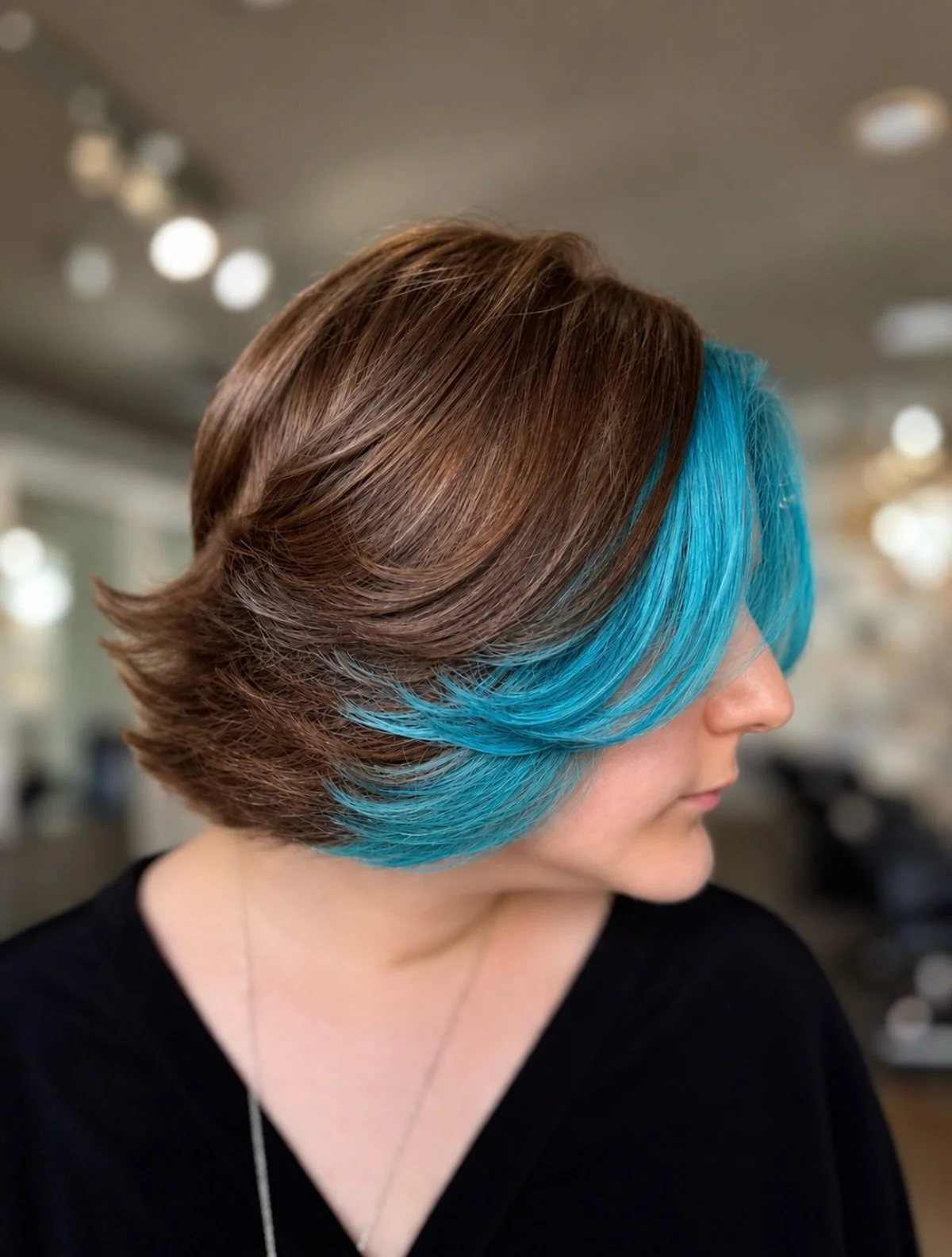 A pop of blue makes everything better 💙✨ This bold turquoise face frame paired with a rich brunette base is the perfect mix of fun and sophistication. Fresh color, fresh cut, and a whole lot of personality!

📍 Pani Style Hair Salon
💙 Ready for you