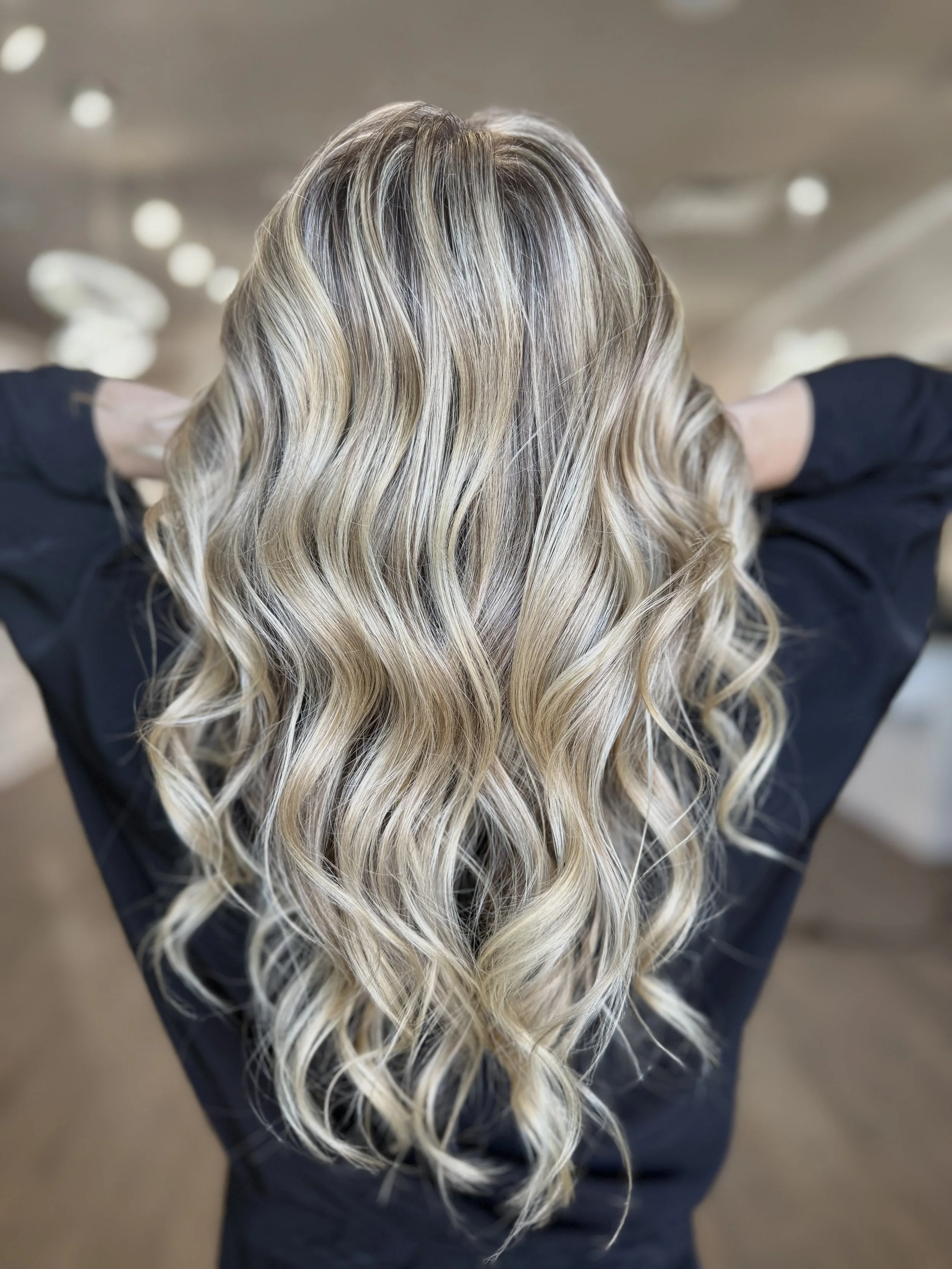 Partial highlights with a soft blonde and brunette blend, enhancing natural color with face-framing brightness at Pani Style Hair Salon, Katy, TX.