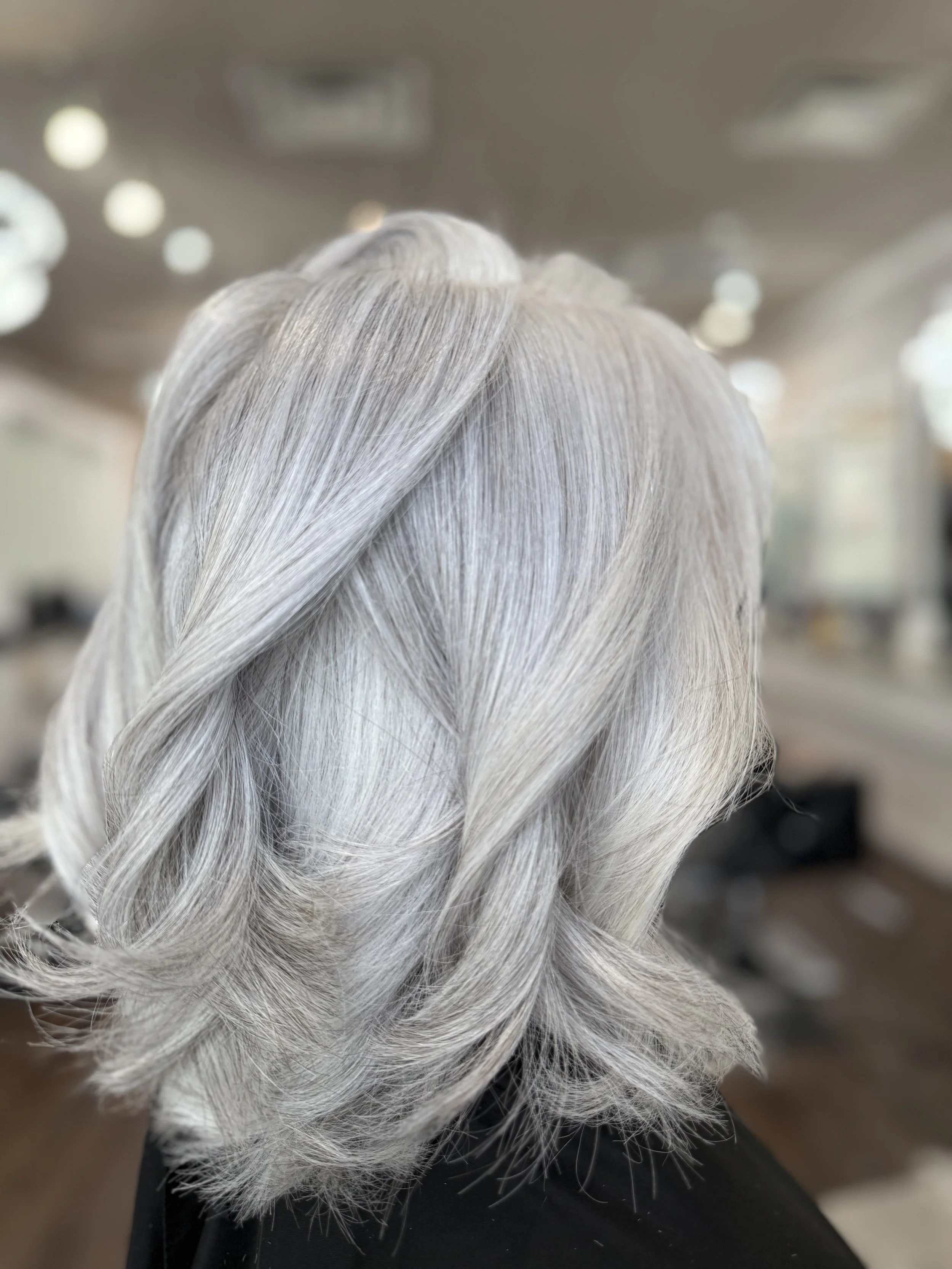 Freshly cut shoulder-length hair with soft layers and warm brunette tones, styled straight with a smooth finish — perfect example of a mid-length women’s haircut at Pani Style Hair Salon in Katy, TX