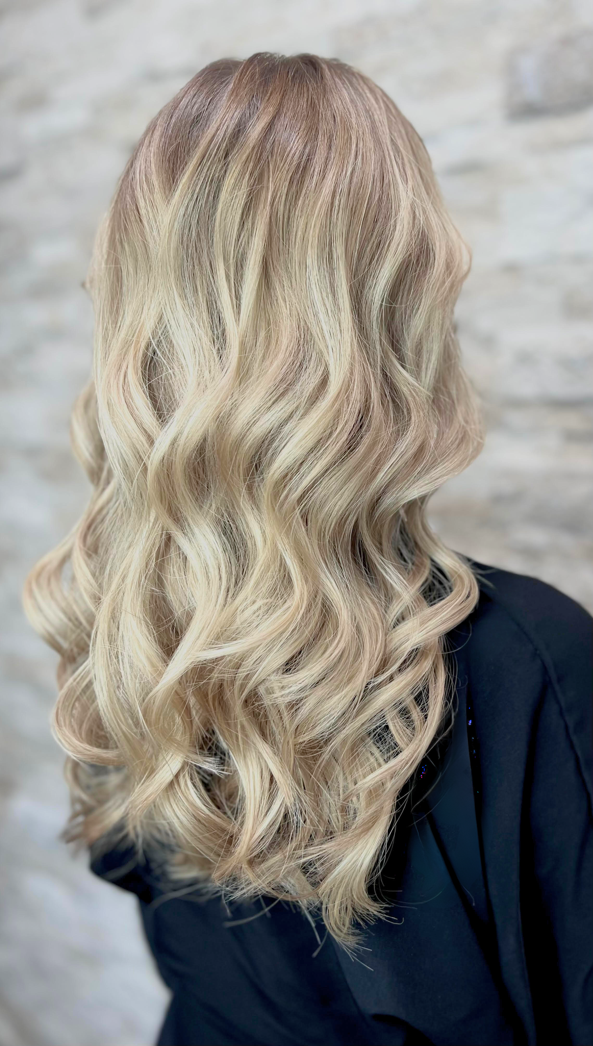 “Back view of freshly styled blonde balayage with soft, natural transitions from root to tip — showcasing a smooth, dimensional finish at Pani Style Hair Salon in Katy, TX.