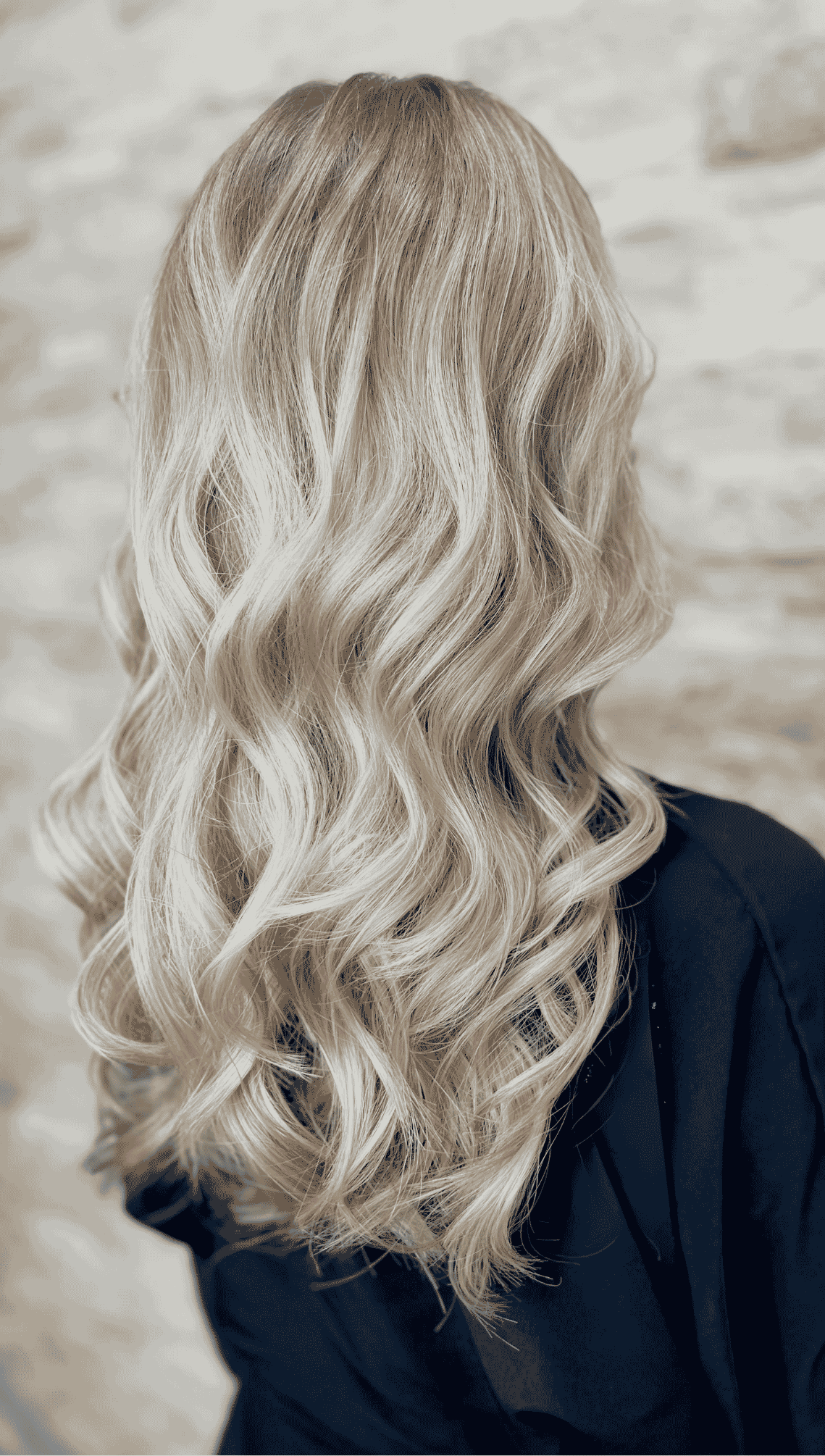 “Back view of freshly styled blonde balayage with soft, natural transitions from root to tip — showcasing a smooth, dimensional finish at Pani Style Hair Salon in Katy, TX.