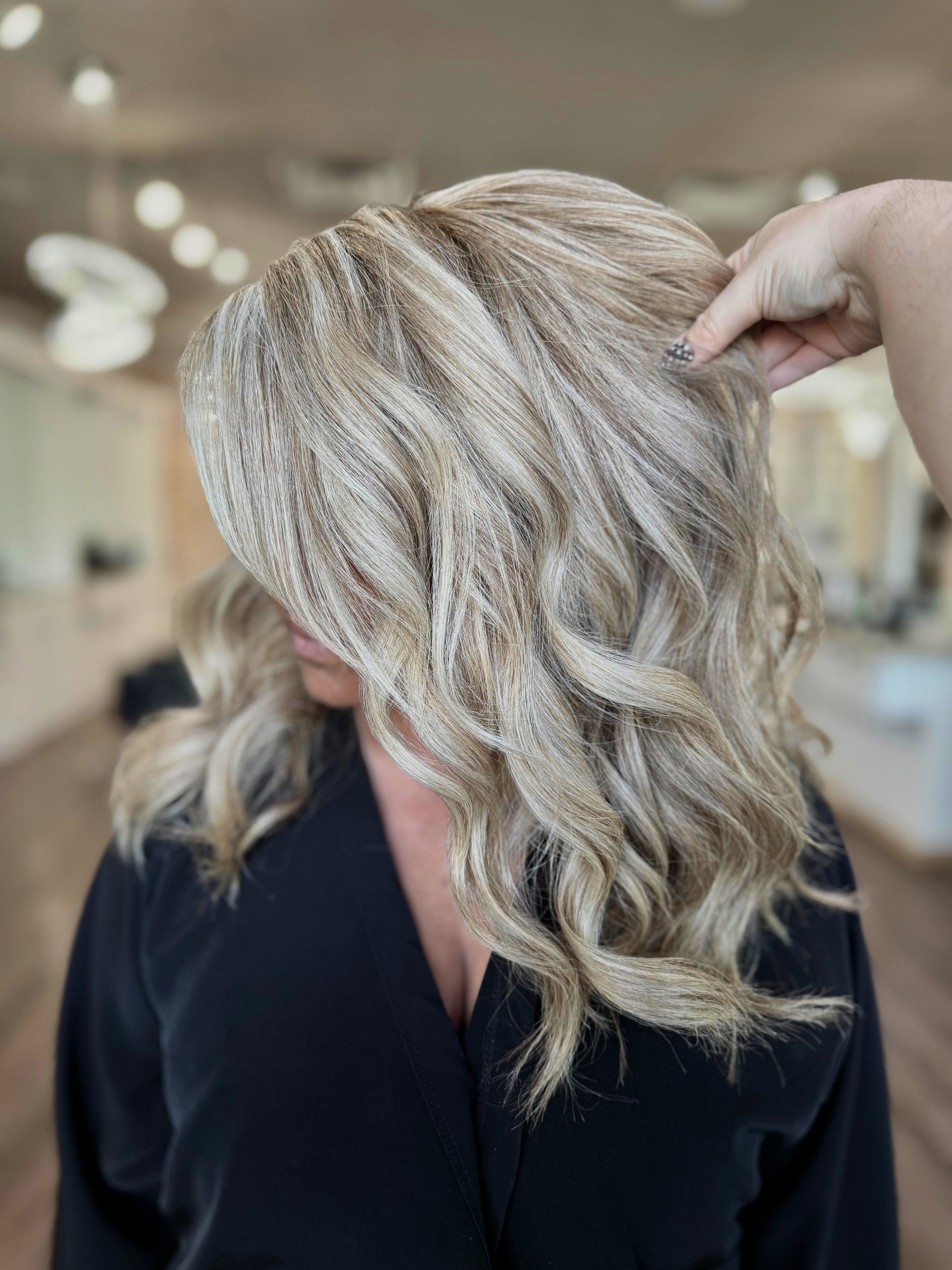 Client after receiving color, highlights, and a haircut at a modern hair salon in Katy, TX