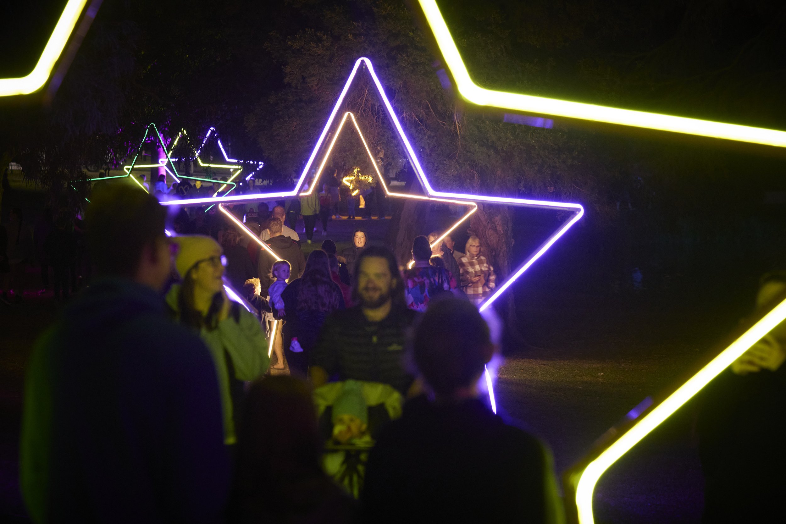 Neon Star Archways wayfinding along path.