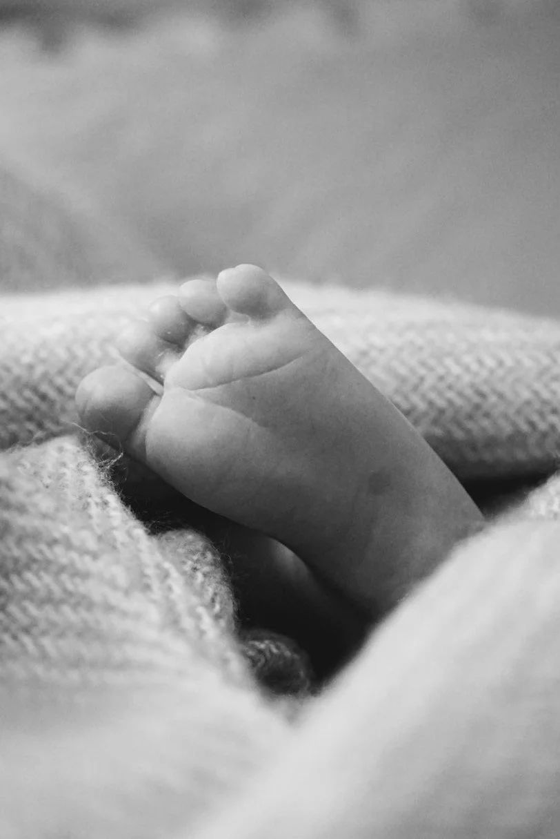 Black and white photograph of a baby foot