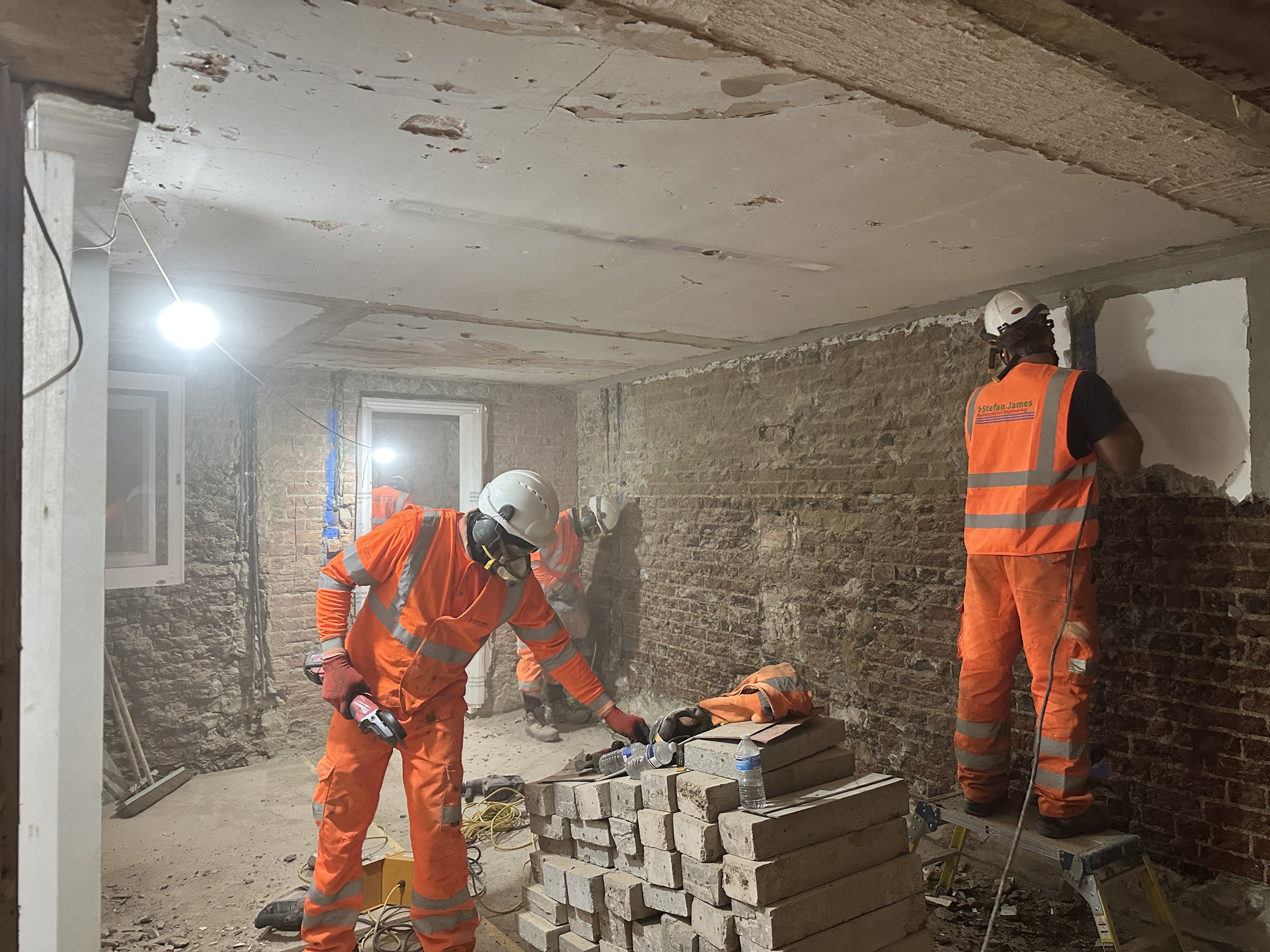 Multi-trade team carrying out controlled internal demolition and strip-out works at Holland Park W11.