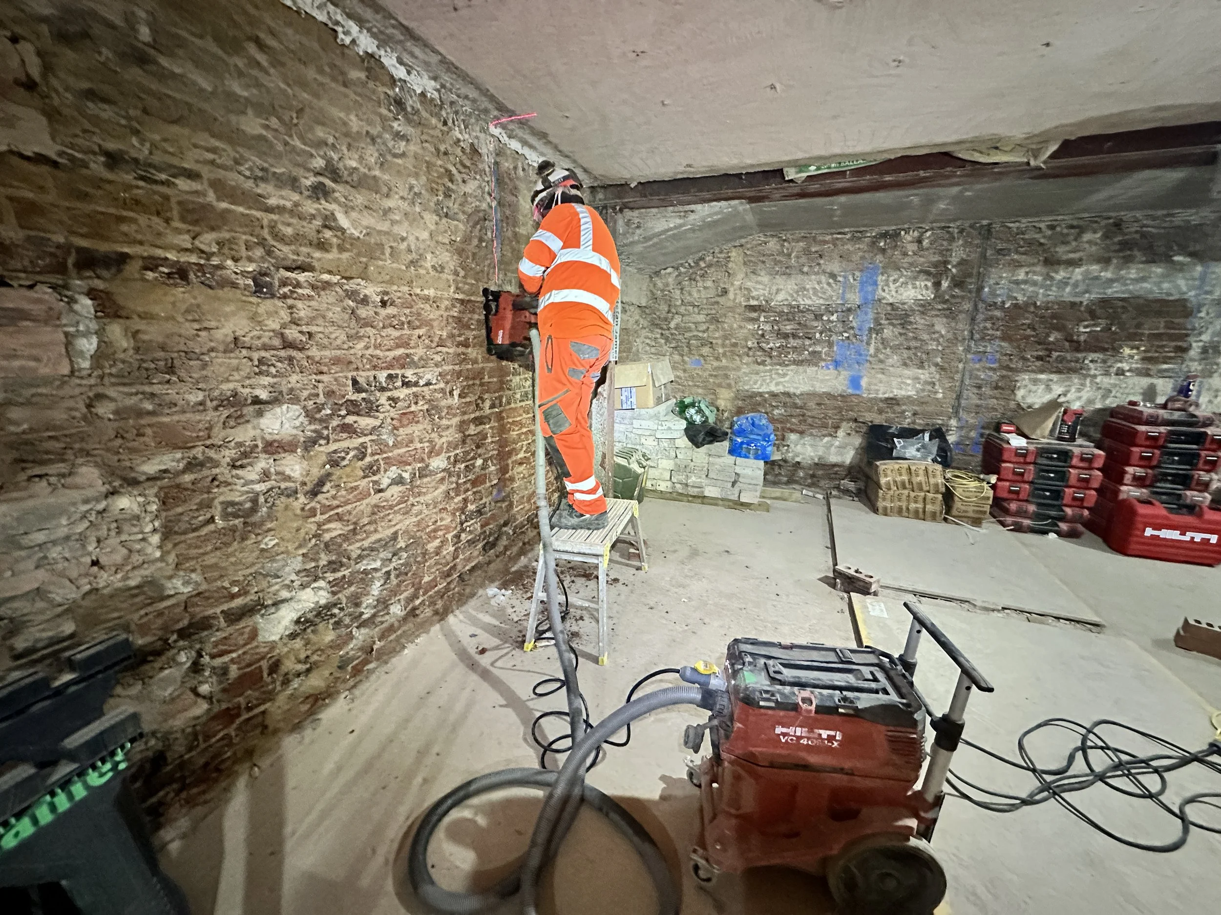 Wall chasing at Holland Park W11 using a dedicated Hilti wall chaser with dust extraction and full PPE