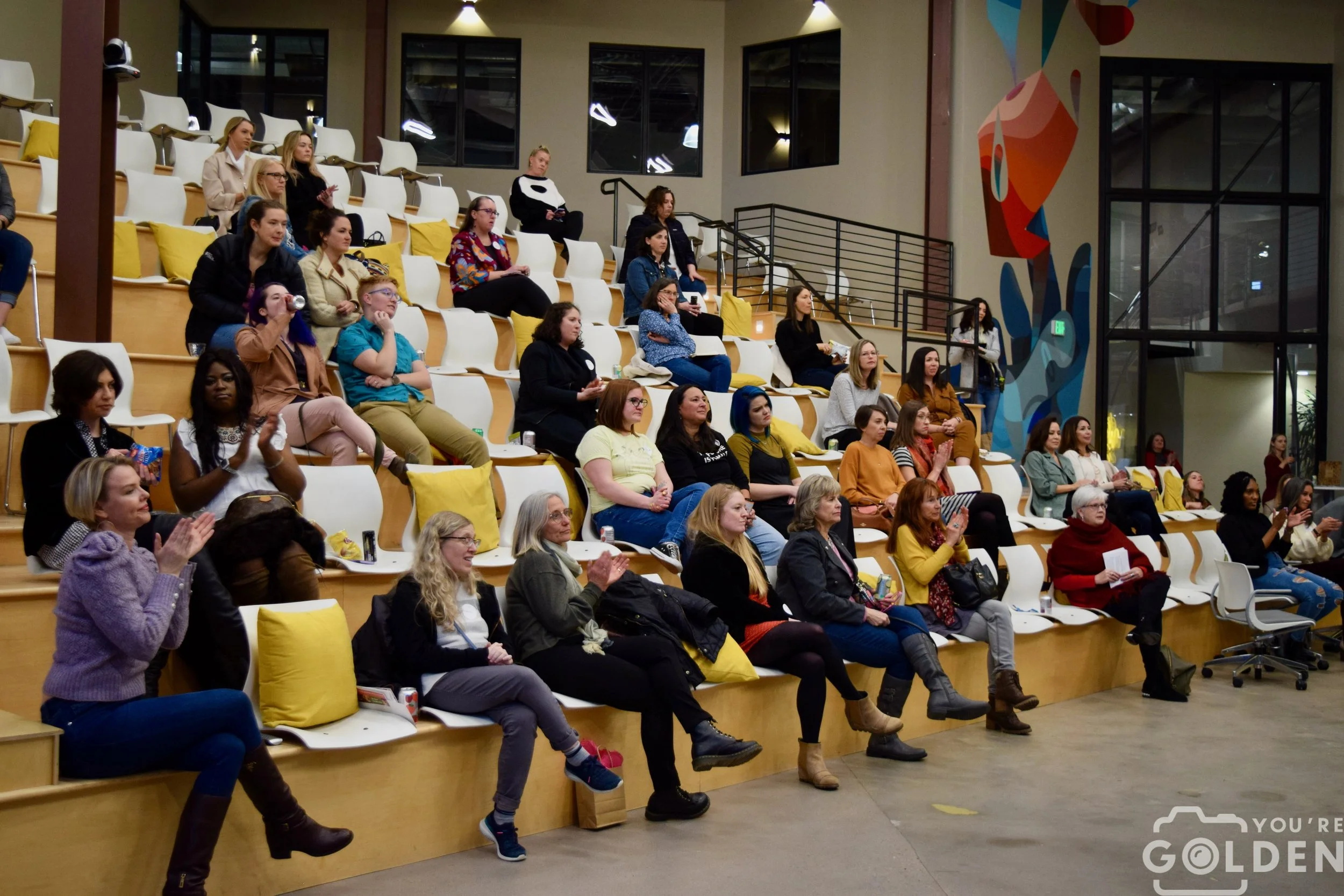 A colorful auditorium of a crowd of women