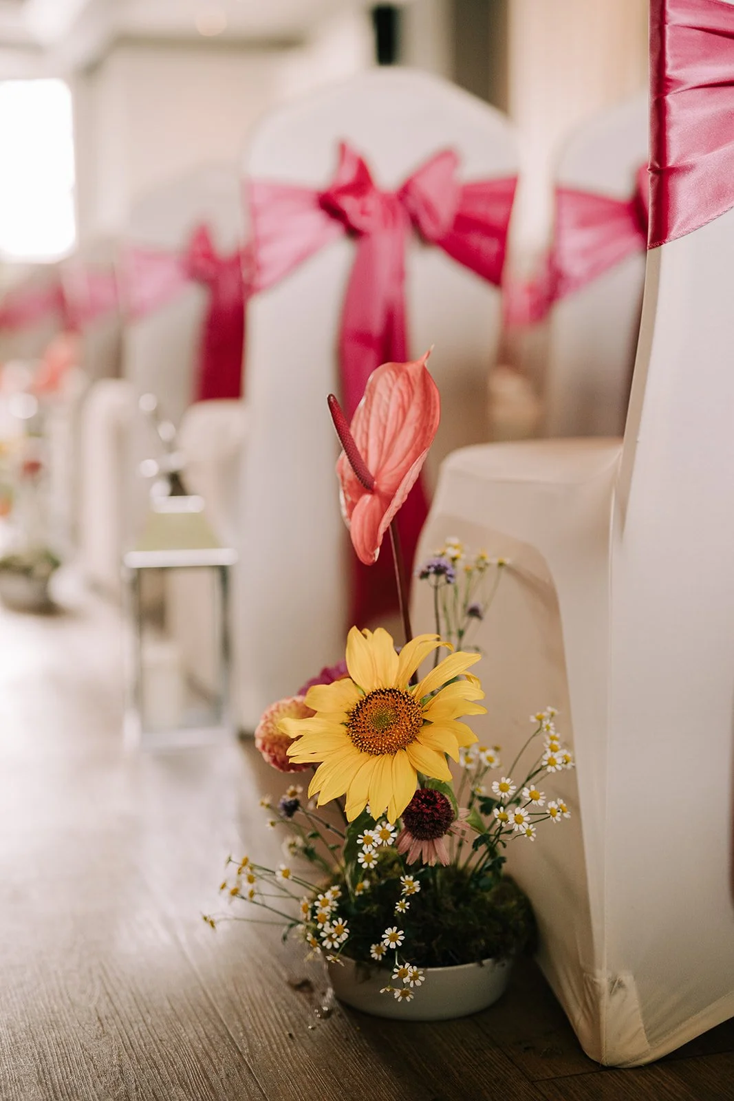 Colourful aisle flowers created by MillieBuds Colour Loving Wedding Florist in Stockport