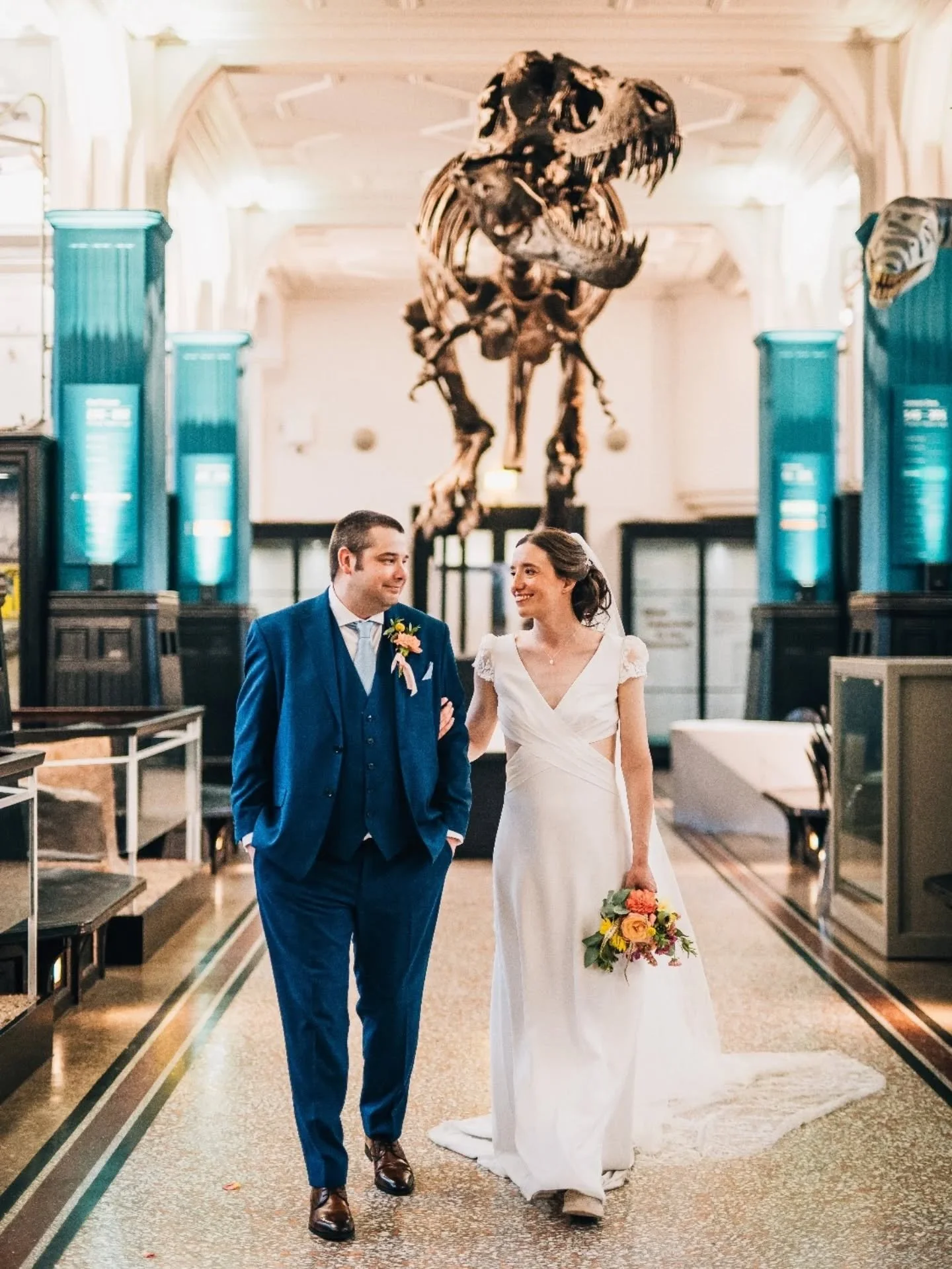 Introducing the WEDDING of Natasha &amp; James 💓💛🩵

Natasha and James got married at the beginning of the summer amongst the dinosaurs 🦖 @mcrmuseum on the hottest day of the year (no joke, supporting the cake maker putting flowers on a butter ici