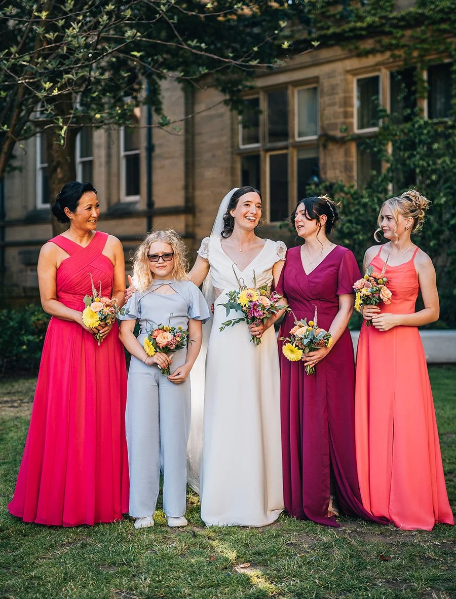 Bride and Bridesmaids in variety of pinks with colourful bouquets by MillieBuds, Stockport