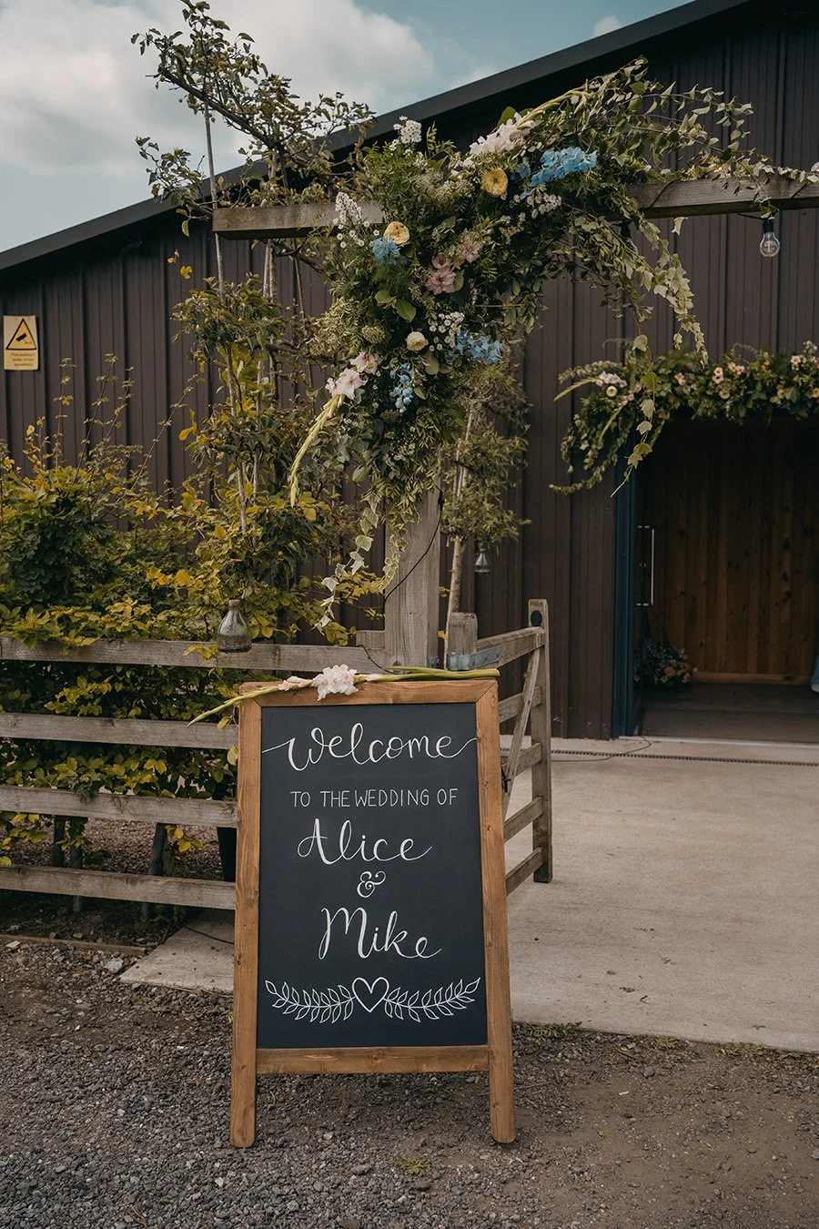Pastel wedding outdoor arch and welcome sign