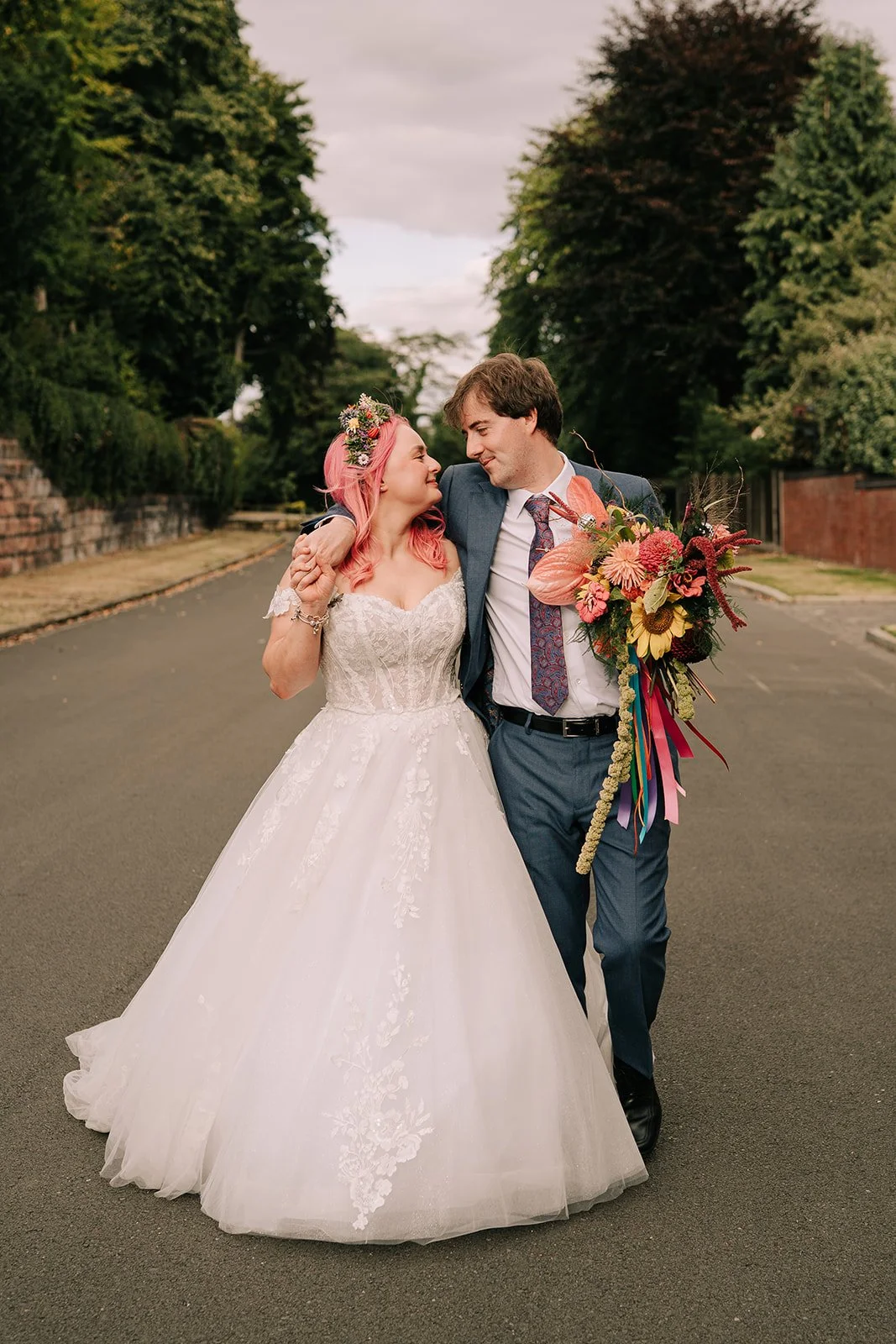 Loved up couple with colourful bridal bouquet