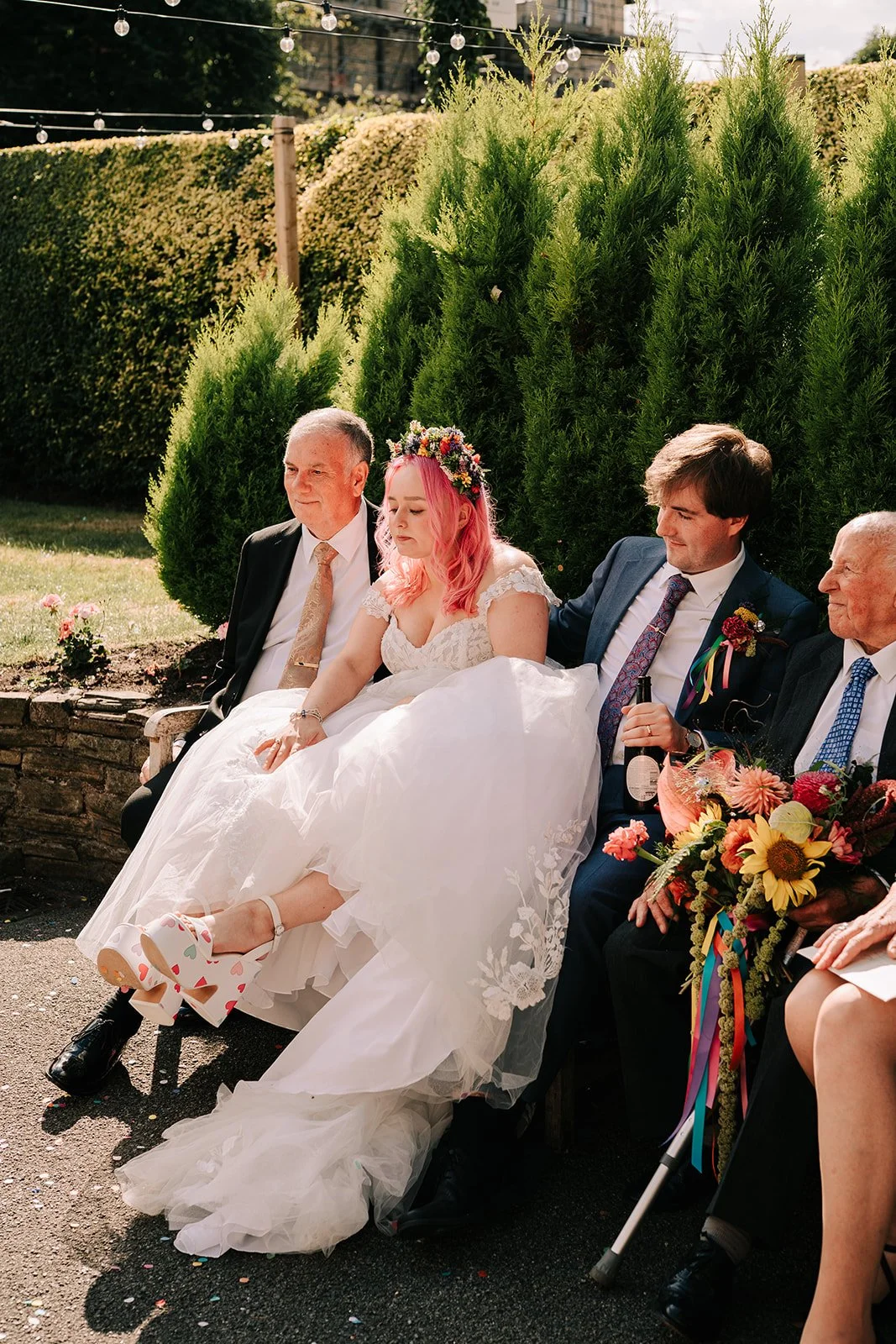 Bride relaxing with feet up with bright colourful bridal bouquet