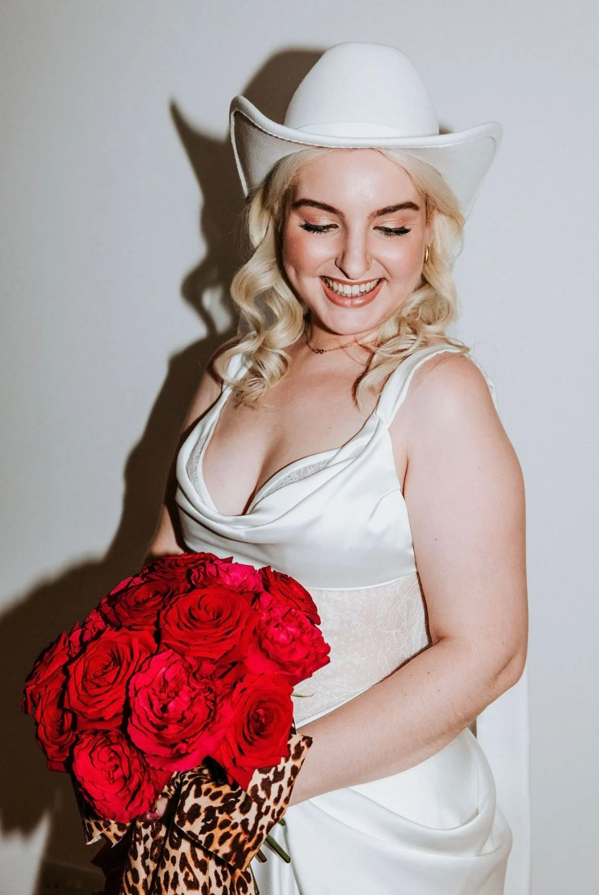 Stunning bride with bright red and pink cartoon style bouquet