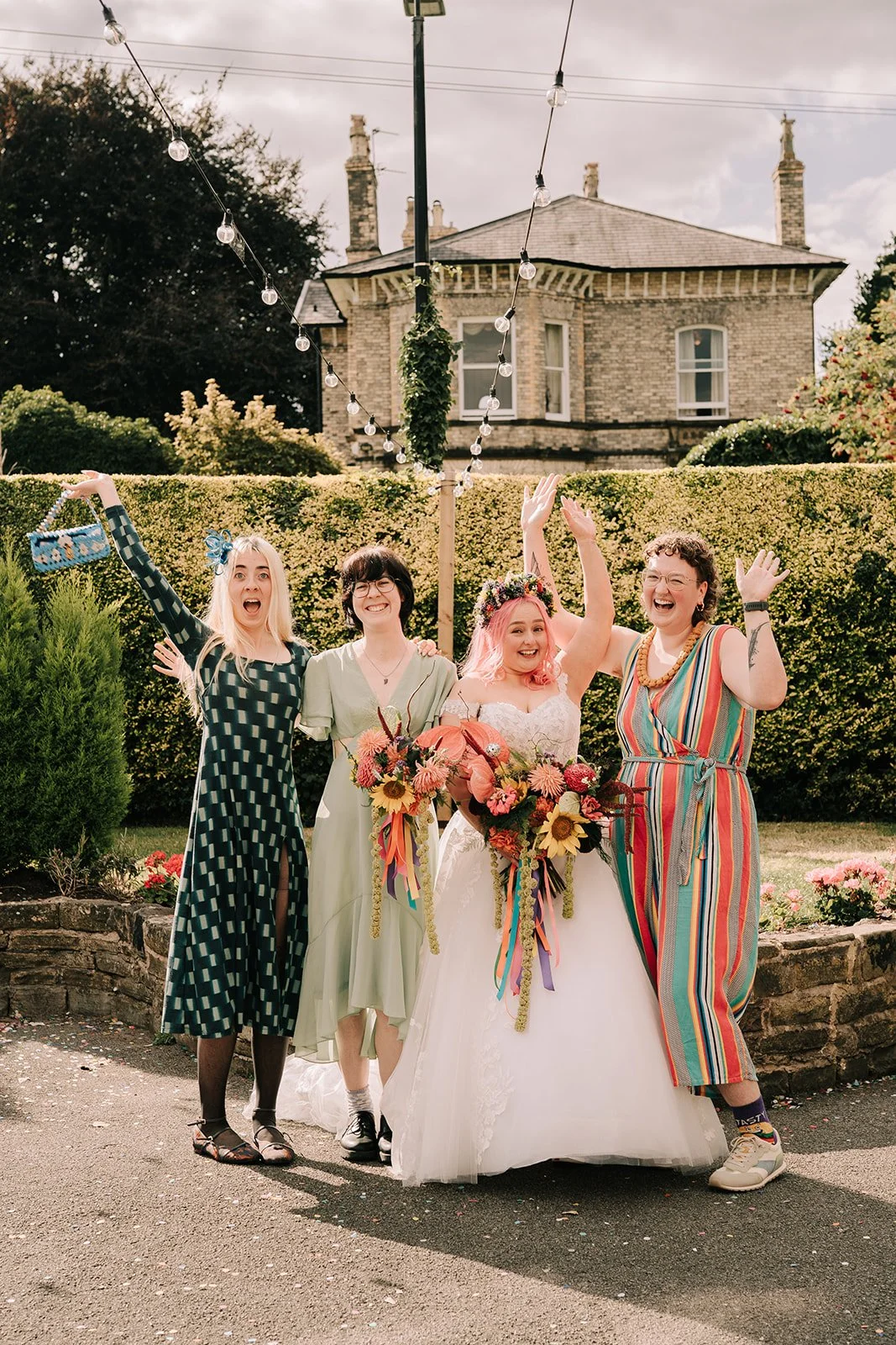 Bride and bridesmaids with colourful wedding flowers