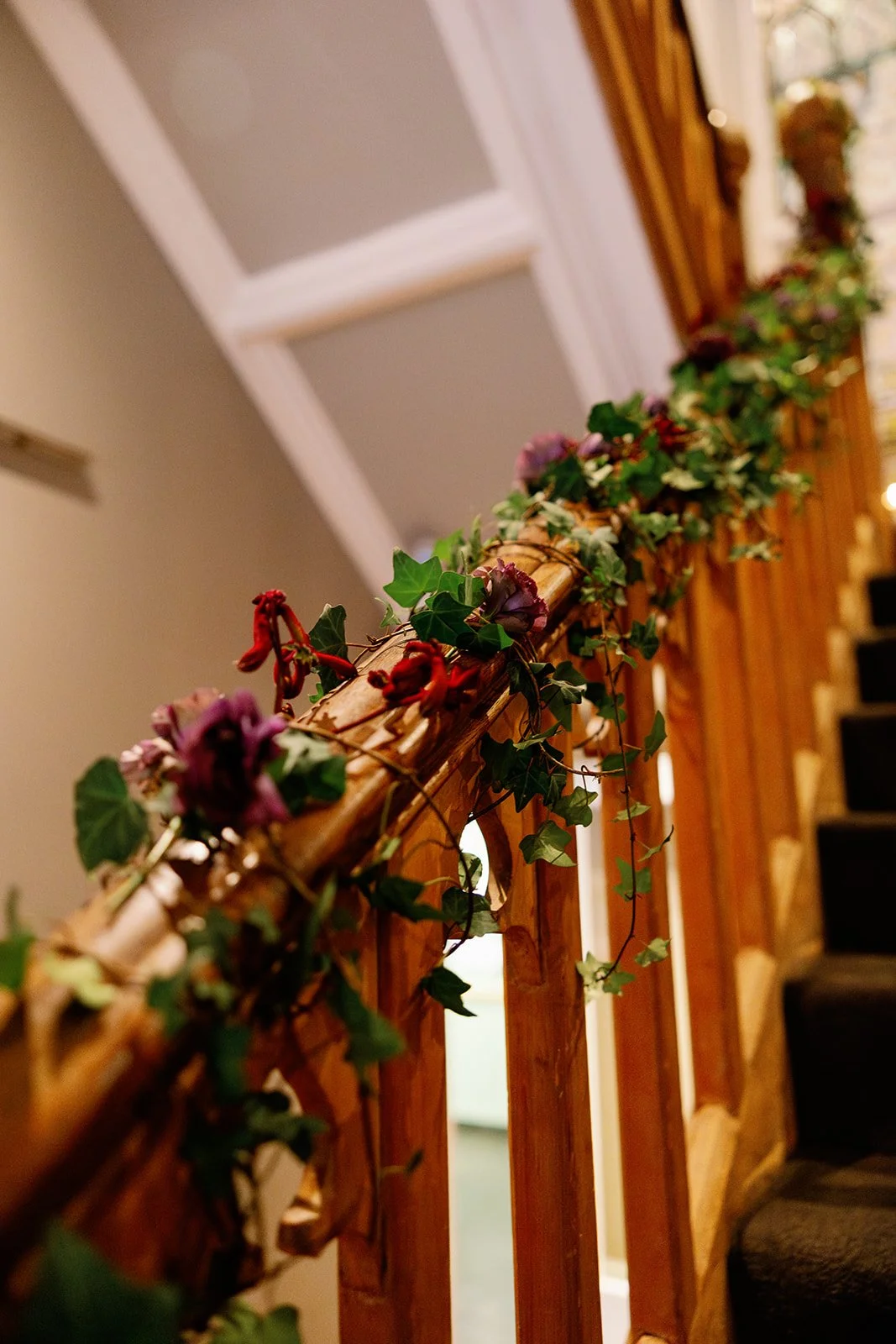 Moody red flowers and foliage staircase banister flowers