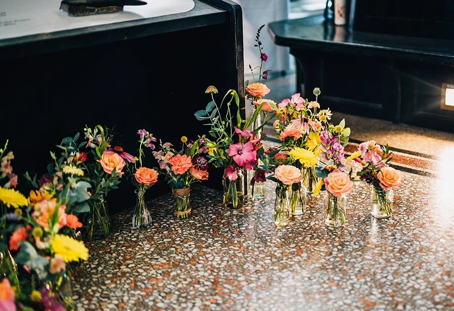 Colourful bud vase ceremony arch