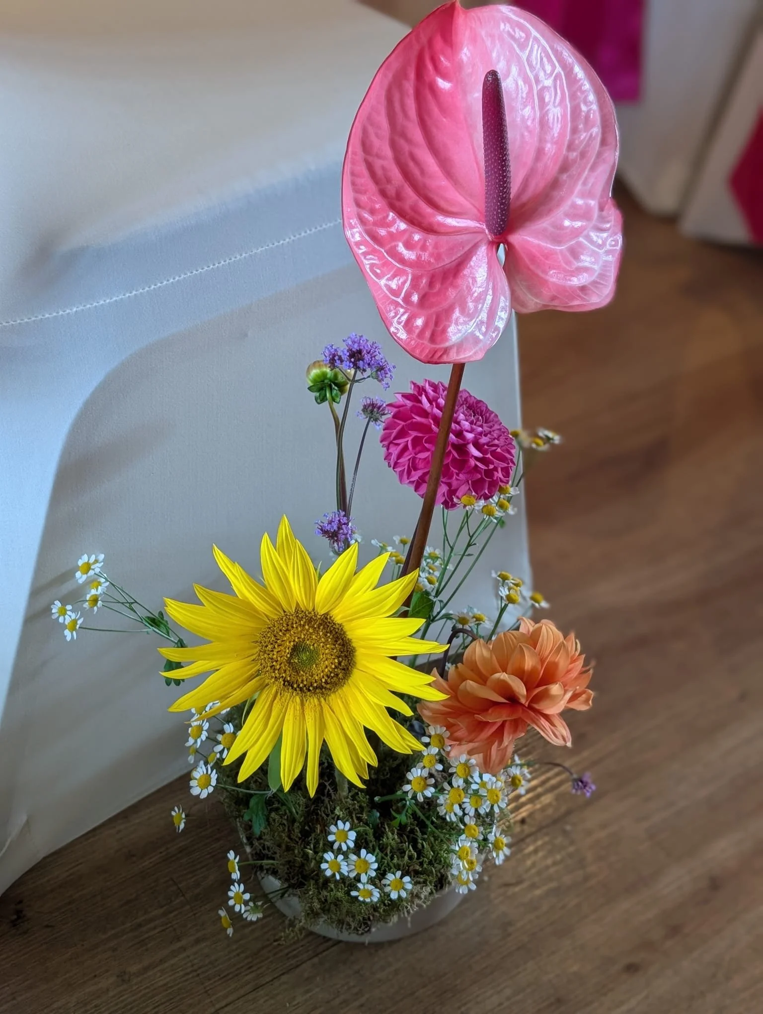 Colourful aisle flowers created by MillieBuds Colour Loving Wedding Florist in Stockport at Bowdon Rooms