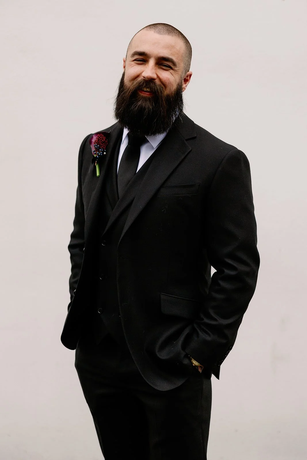 Groom with dark purple buttonhole